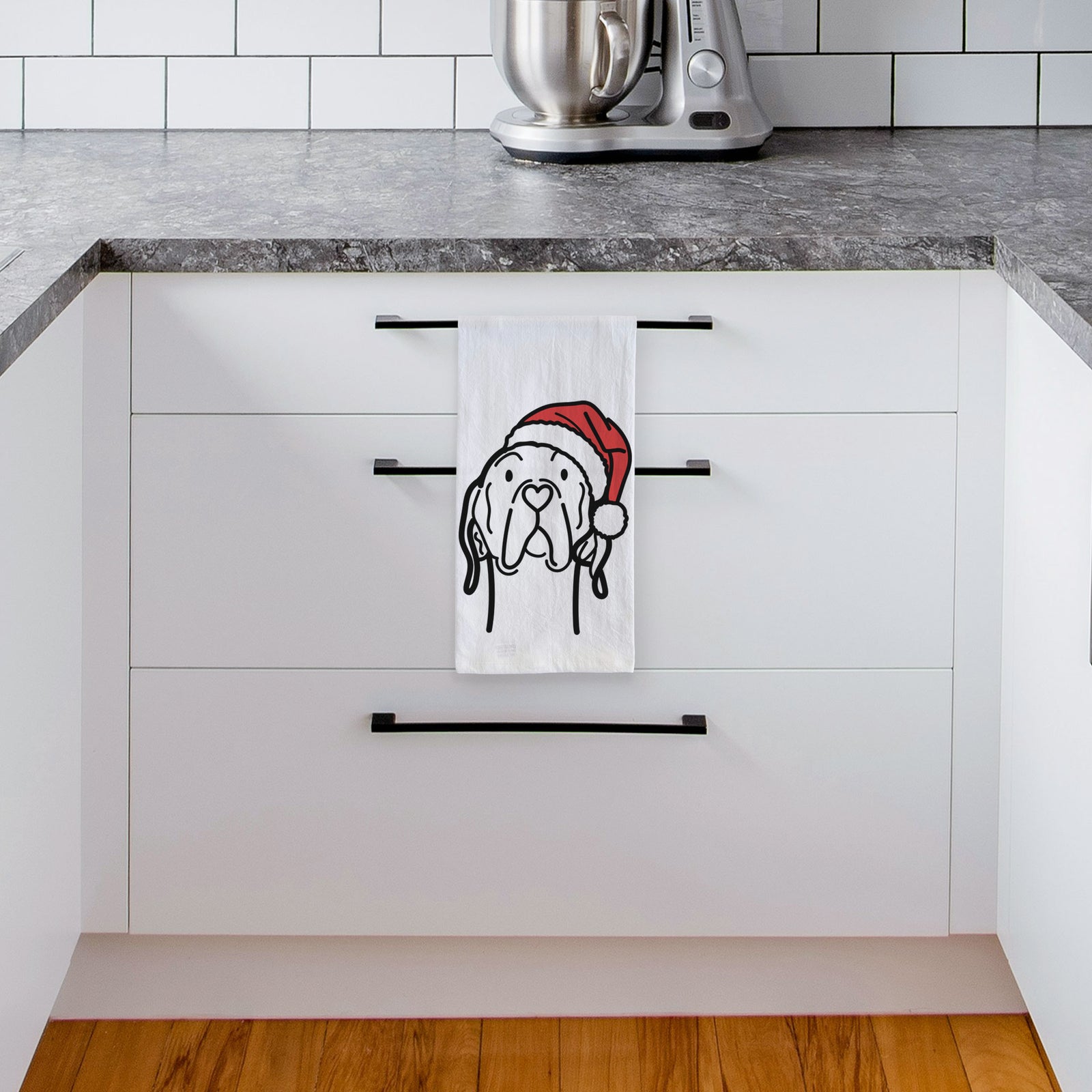 Minimalist line drawing of an English Pointer wearing a Santa hat on a tea towel, hanging on an oven door in a kitchen