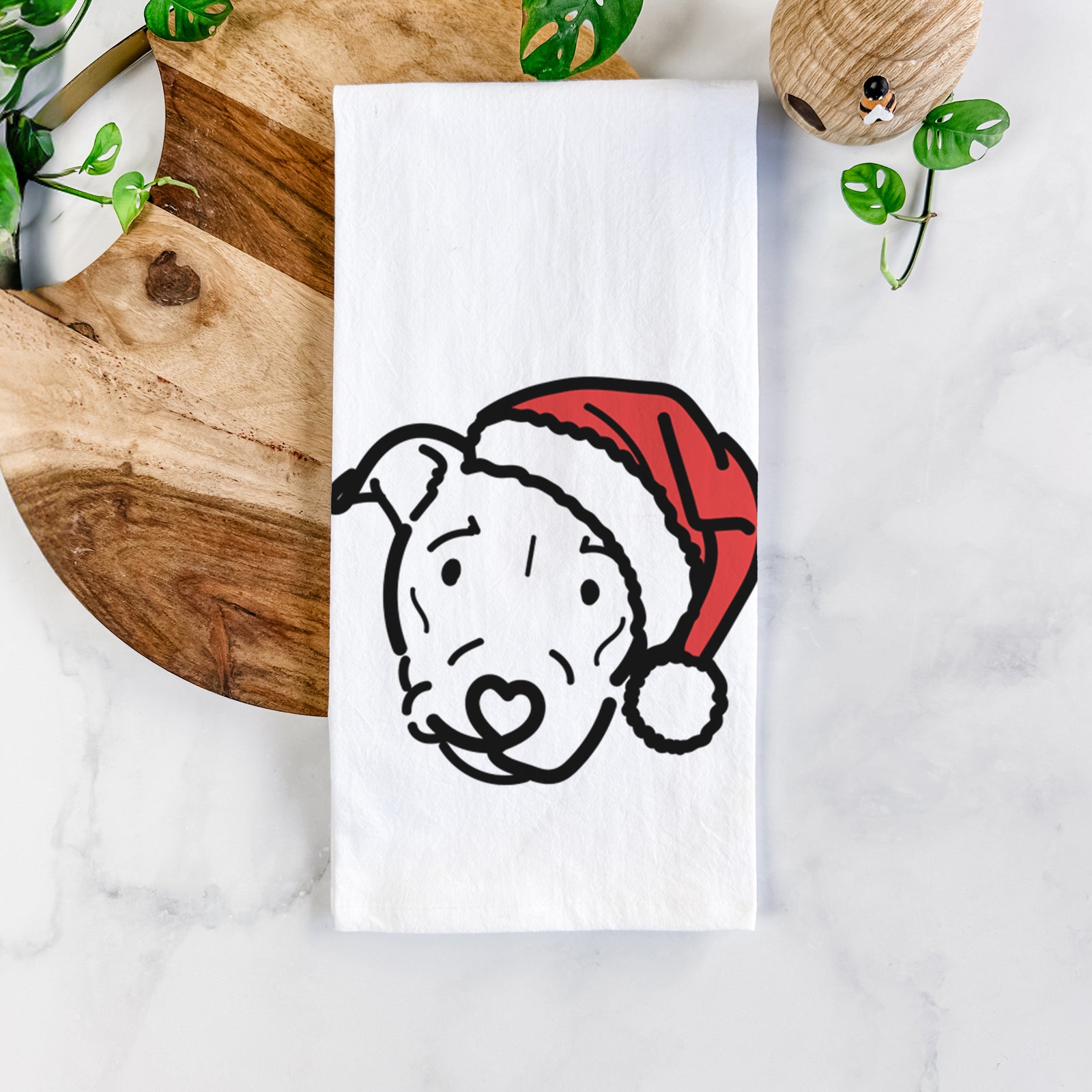 Minimalist line drawing of Ernie the Pitbull Mix wearing a Santa hat on a tea towel