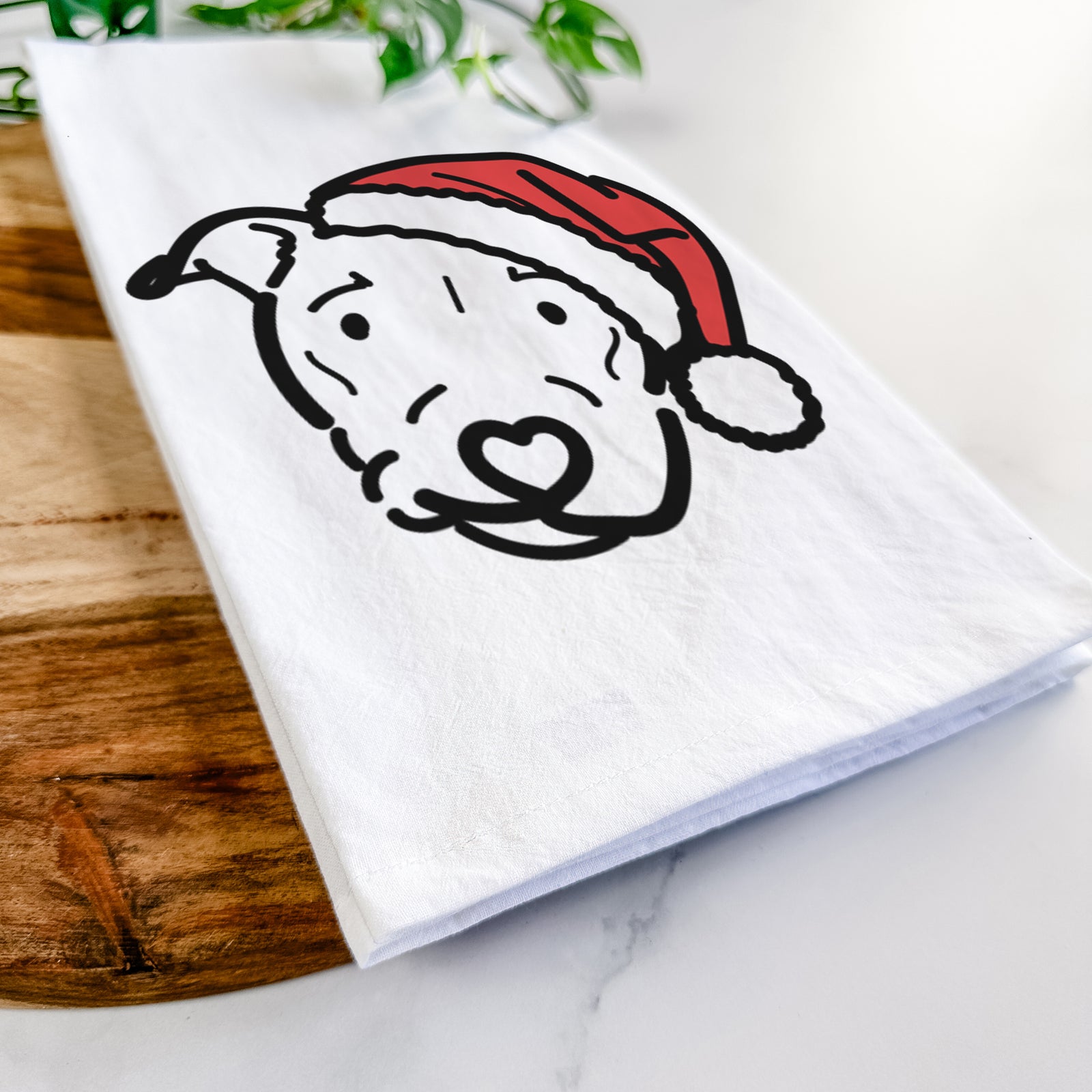 Minimalist line drawing of Ernie the Pitbull Mix wearing a Santa hat on a tea towel