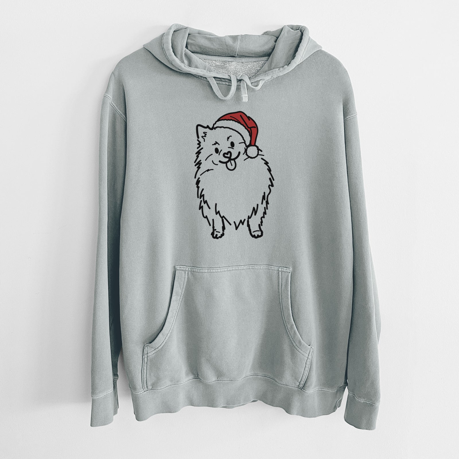 Minimalist line drawing of Fern the Pomeranian wearing a Santa hat on a Sage Unisex pigment dyed hoodie