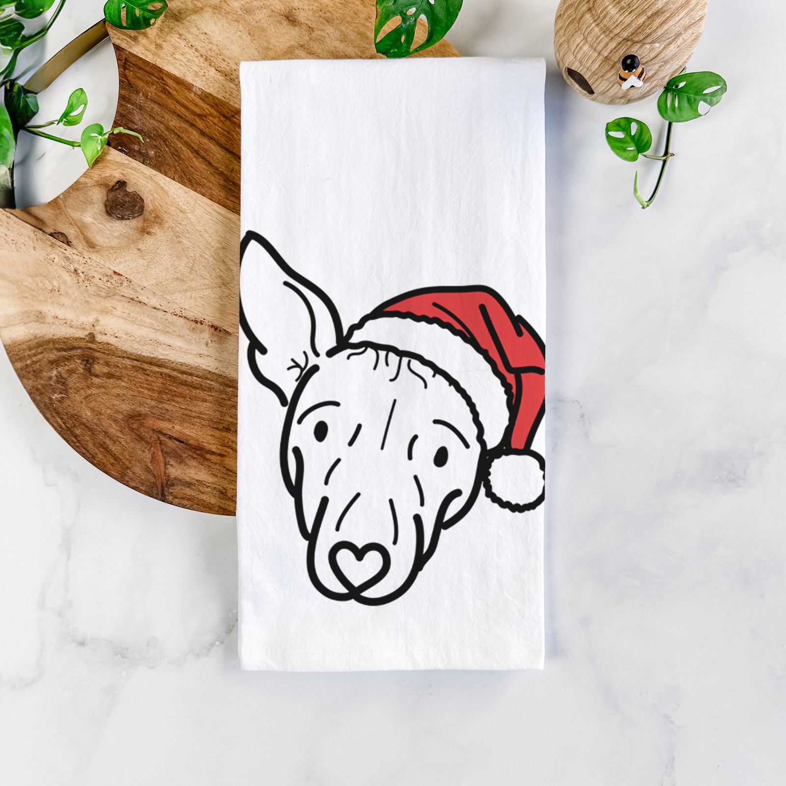Minimalist line drawing of Georgia the American Hairless Terrier wearing a Santa hat on a tea towel