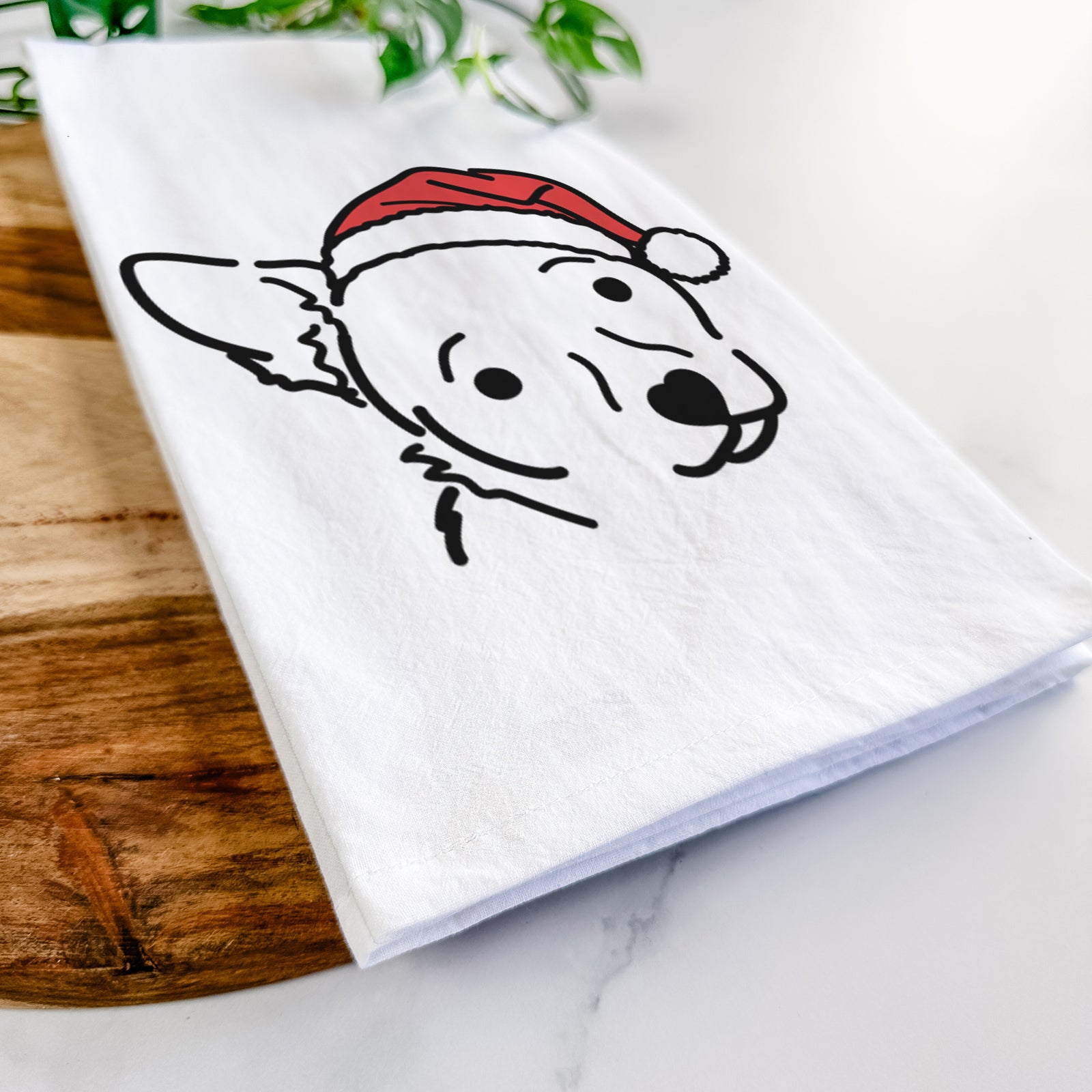Minimalist line drawing of GiGi the Chihuahua Mix wearing a Santa hat on a tea towel