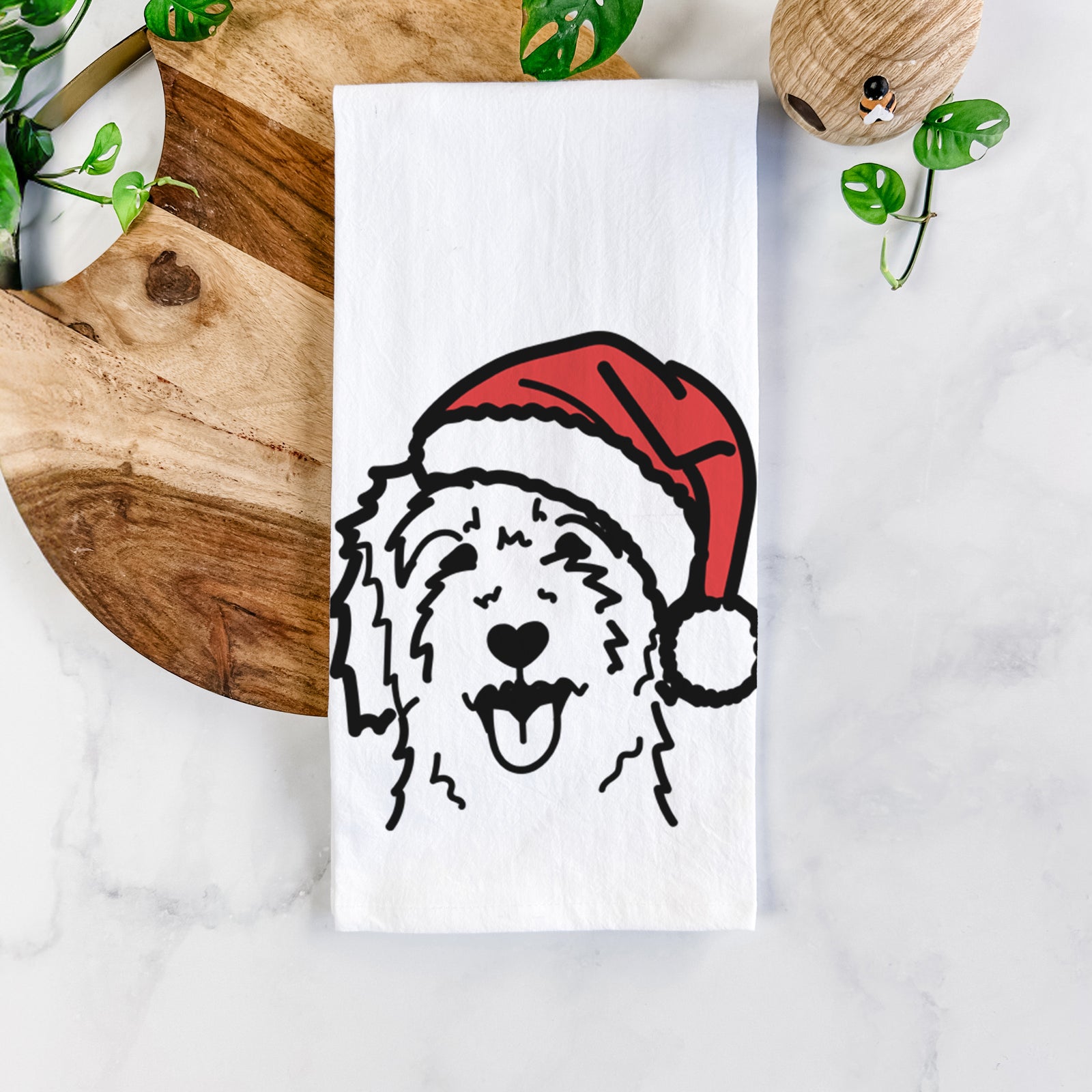 Minimalist line drawing of a Goldendoodle wearing a Santa hat on a tea towel