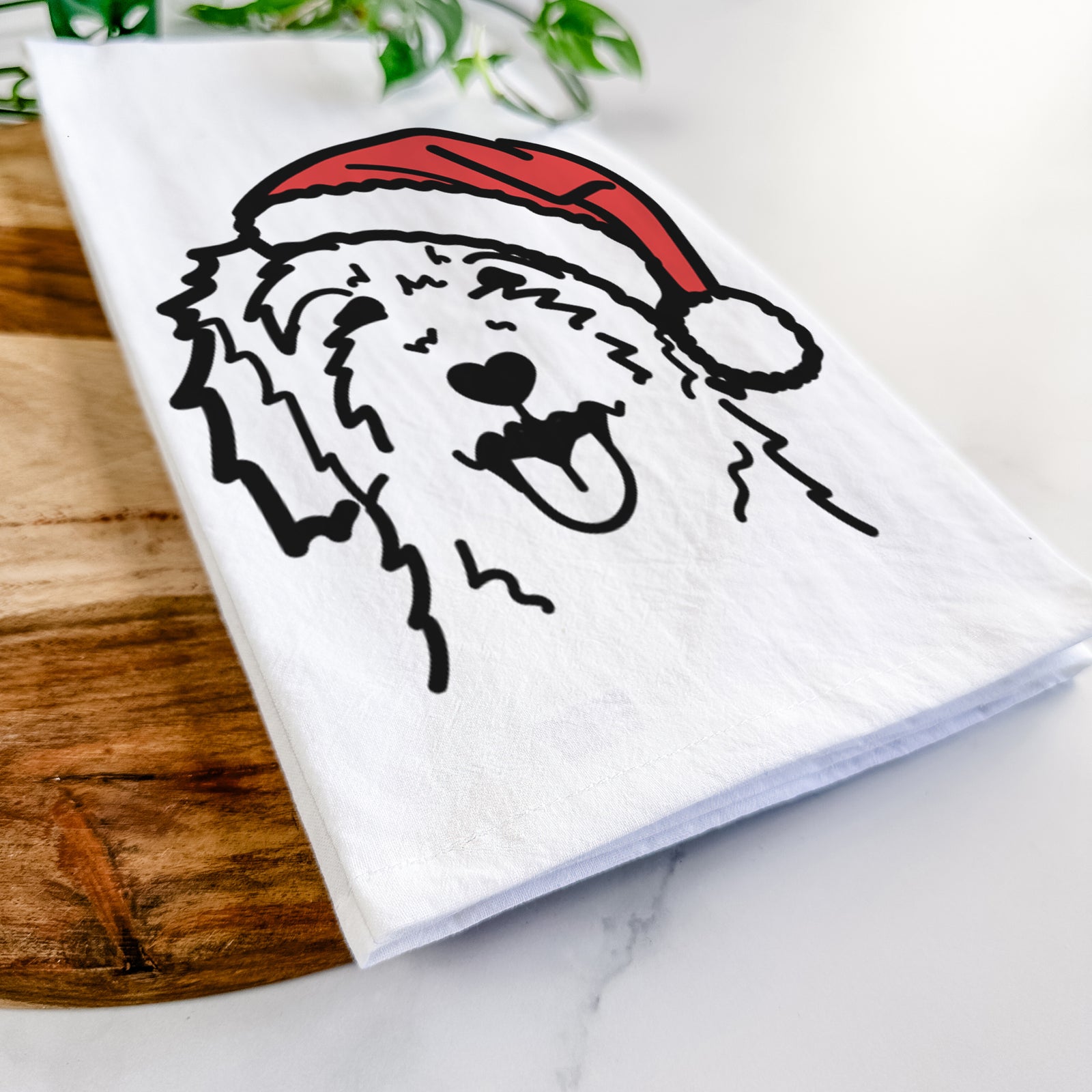 Minimalist line drawing of a Goldendoodle wearing a Santa hat on a tea towel
