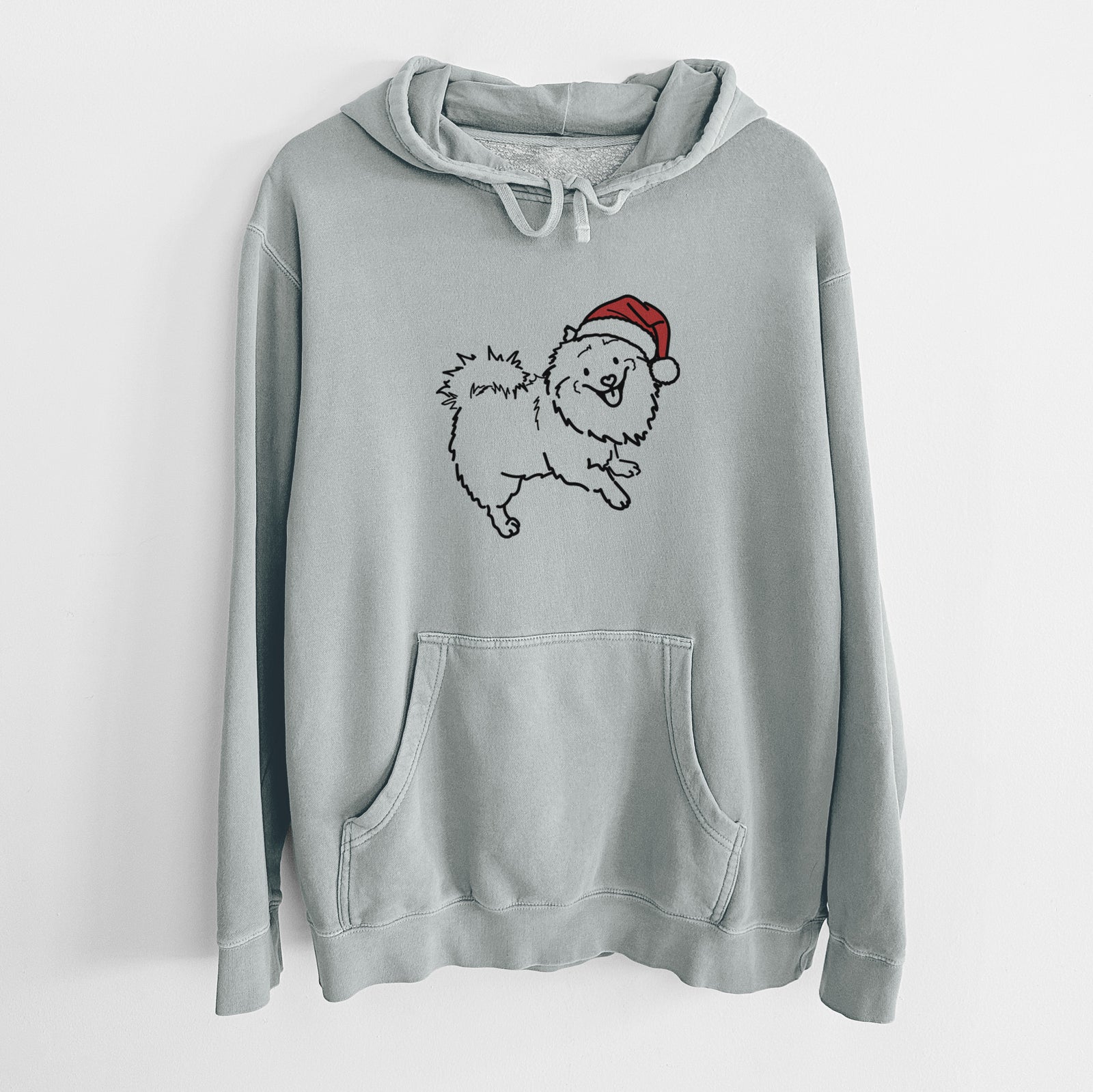 Minimalist line drawing of Goldie the Pomeranian Mix wearing a Santa hat on a Sage Unisex pigment dyed hoodie