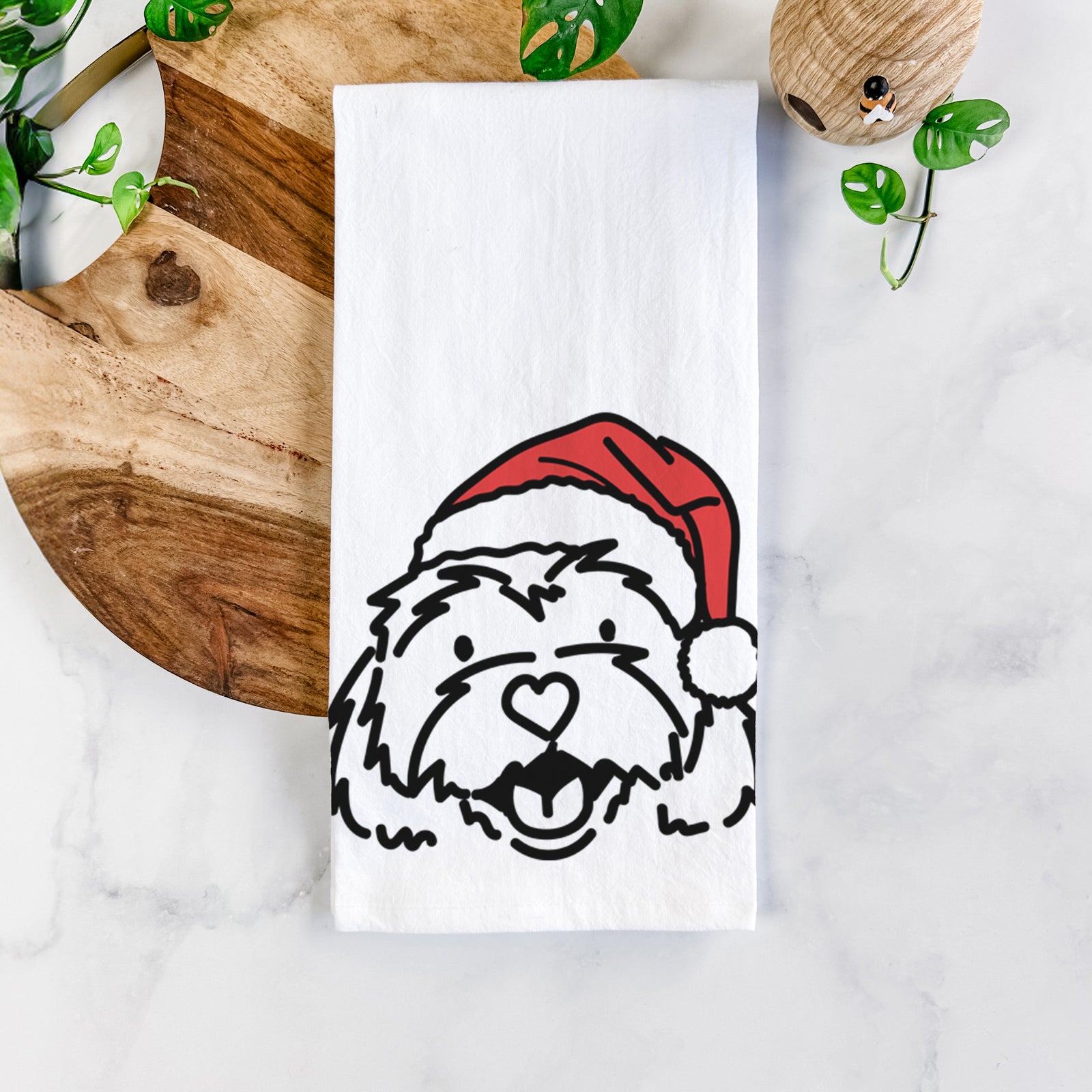 Minimalist line drawing of Harry the Cavachon wearing a Santa hat on a tea towel