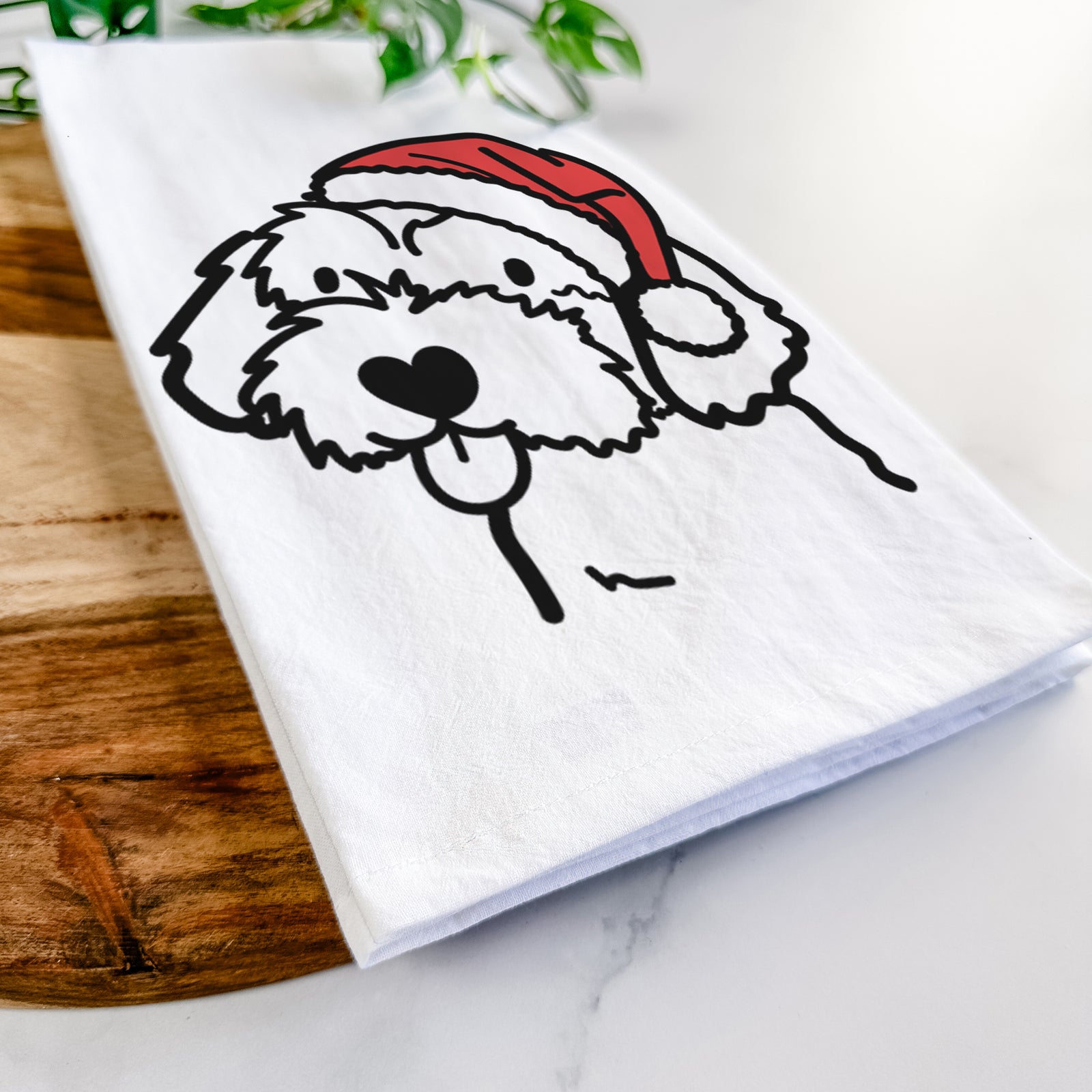 Minimalist line drawing of a Havapoo wearing a Santa hat on a tea towel