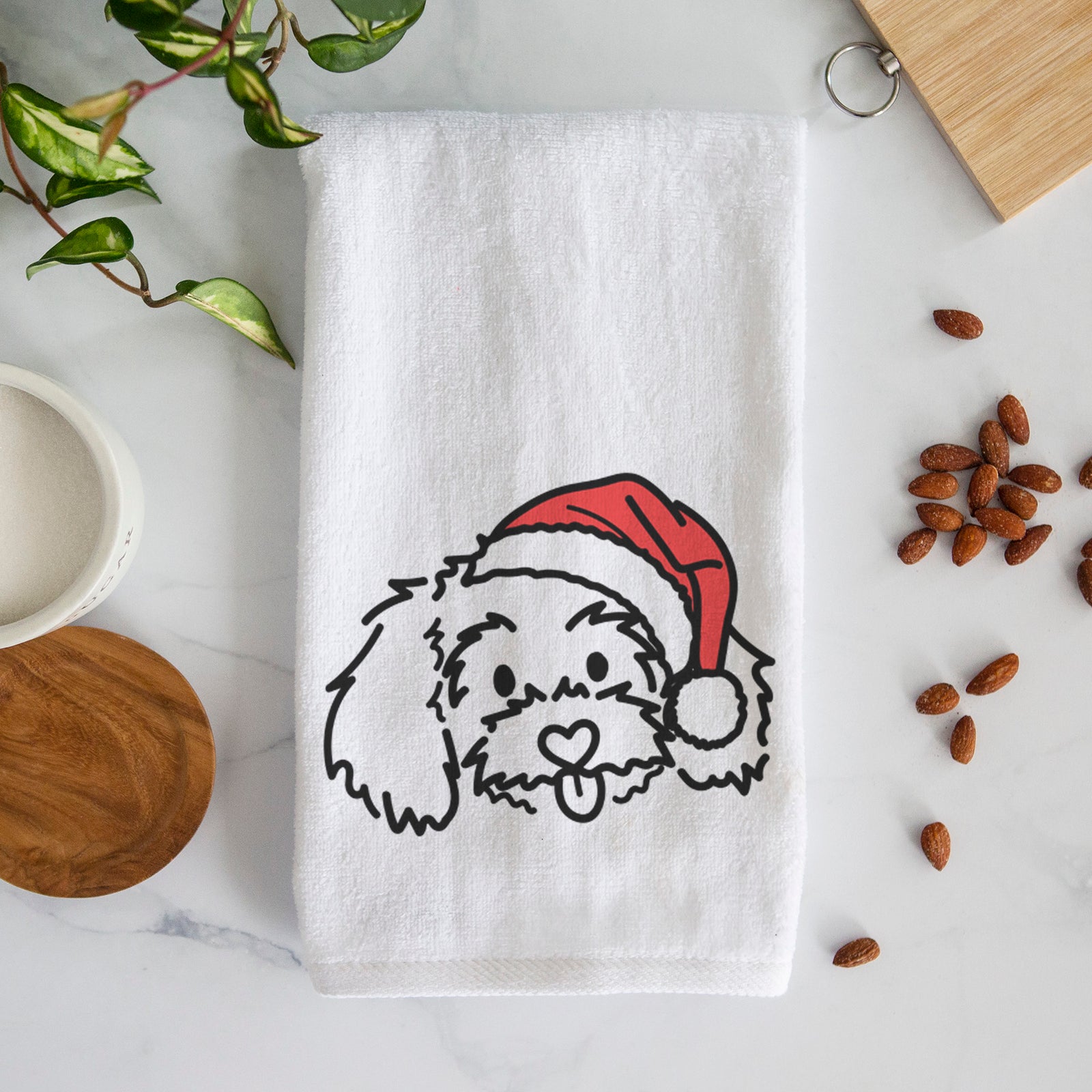 Minimalist line drawing of Holly the Maltipoo wearing a Santa hat on a decorative hand towel