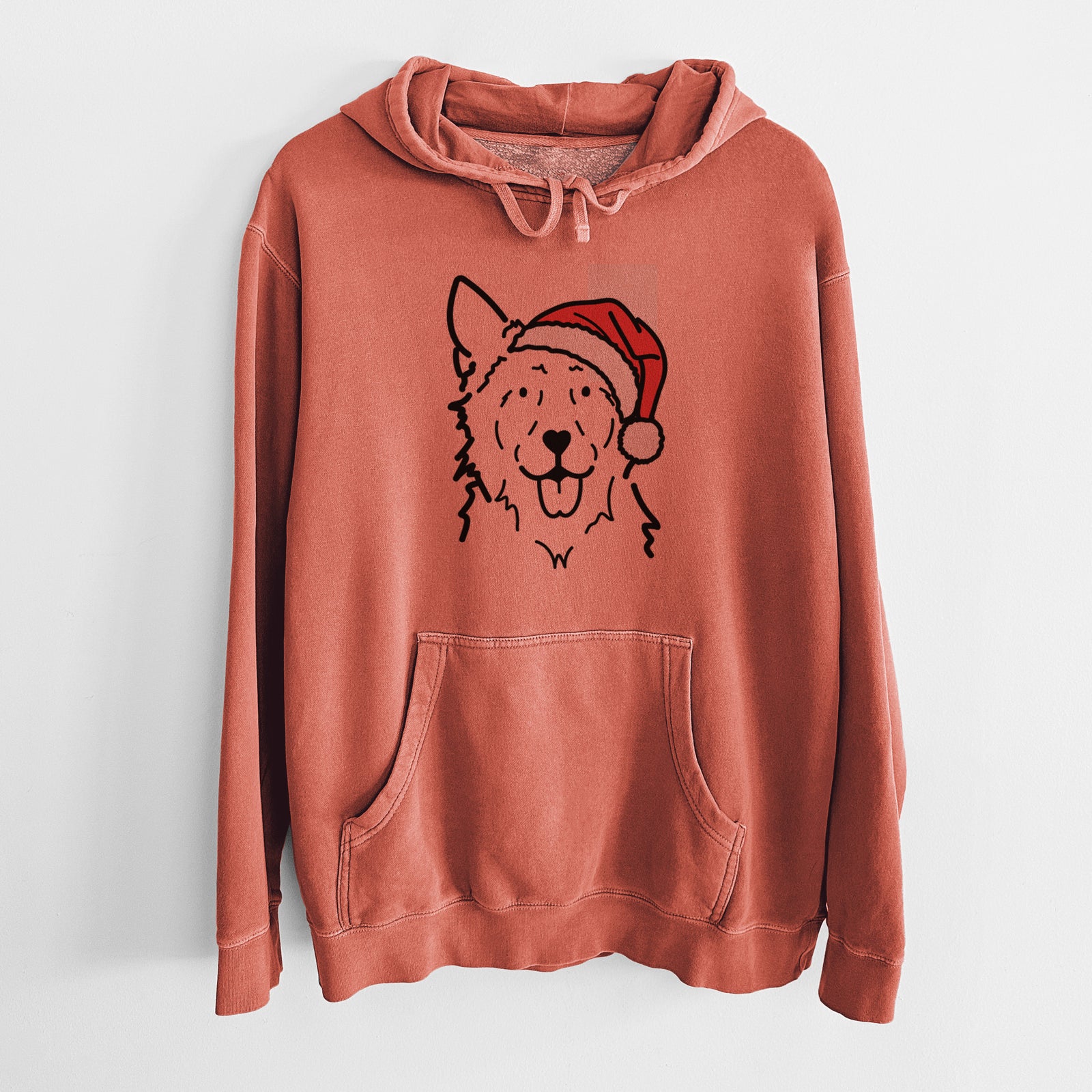 Minimalist line drawing of Jack the Mudi wearing a Santa hat on an Amber Unisex pigment dyed hoodie