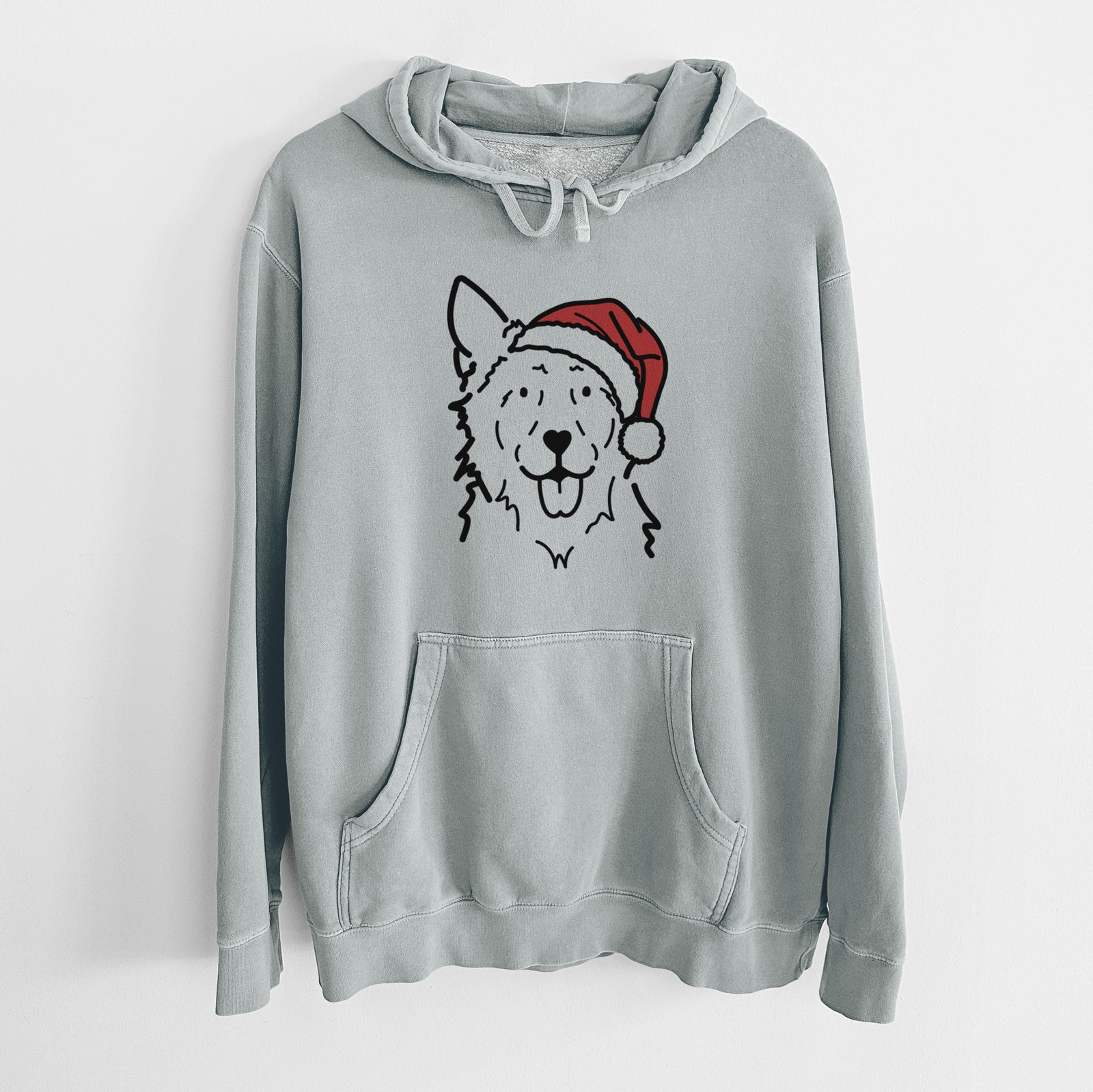 Minimalist line drawing of Jack the Mudi wearing a Santa hat on a Sage Unisex pigment dyed hoodie