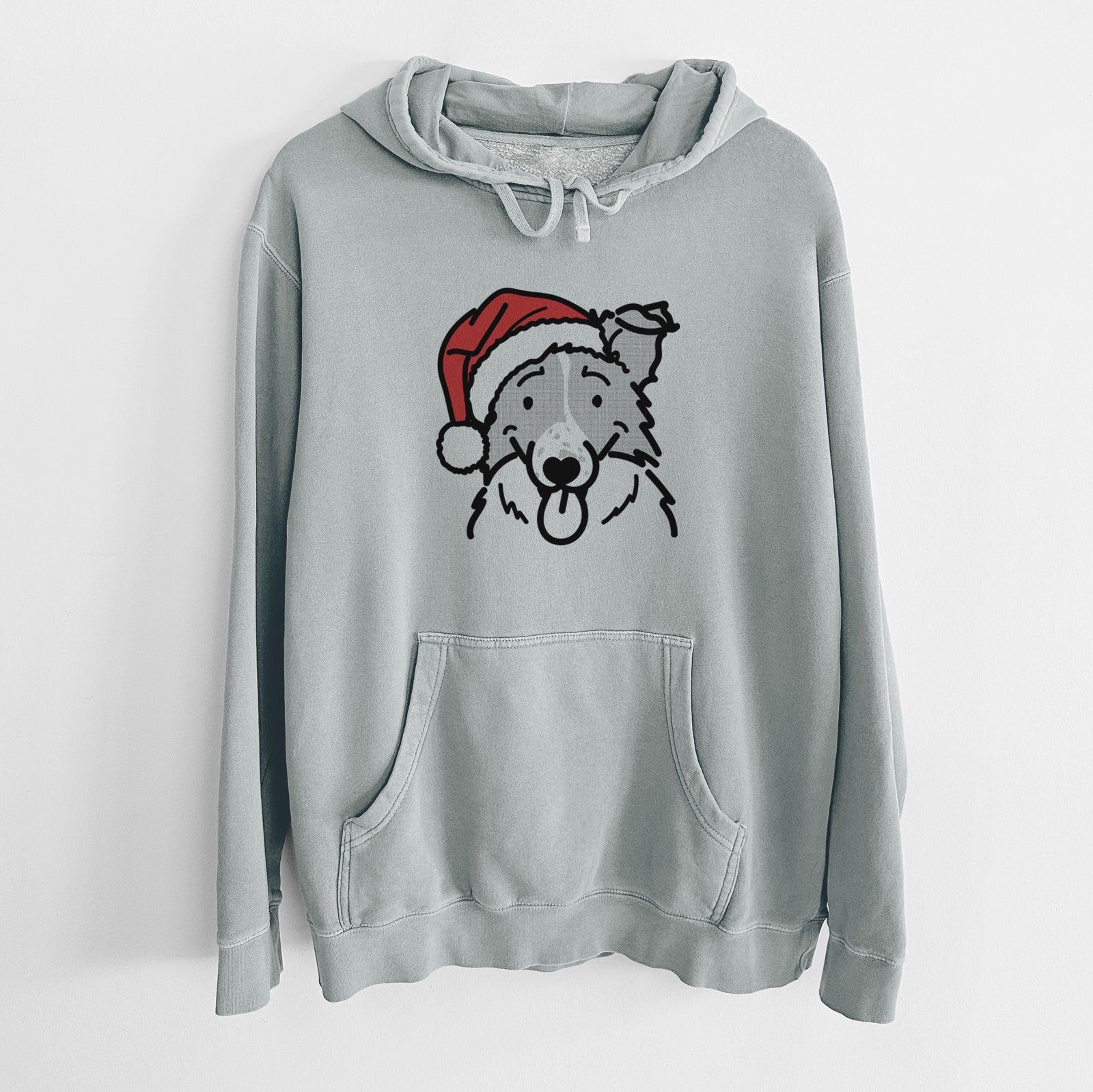 Minimalist line drawing of Jam the Border Collie wearing a Santa hat on a Sage Unisex pigment dyed hoodie