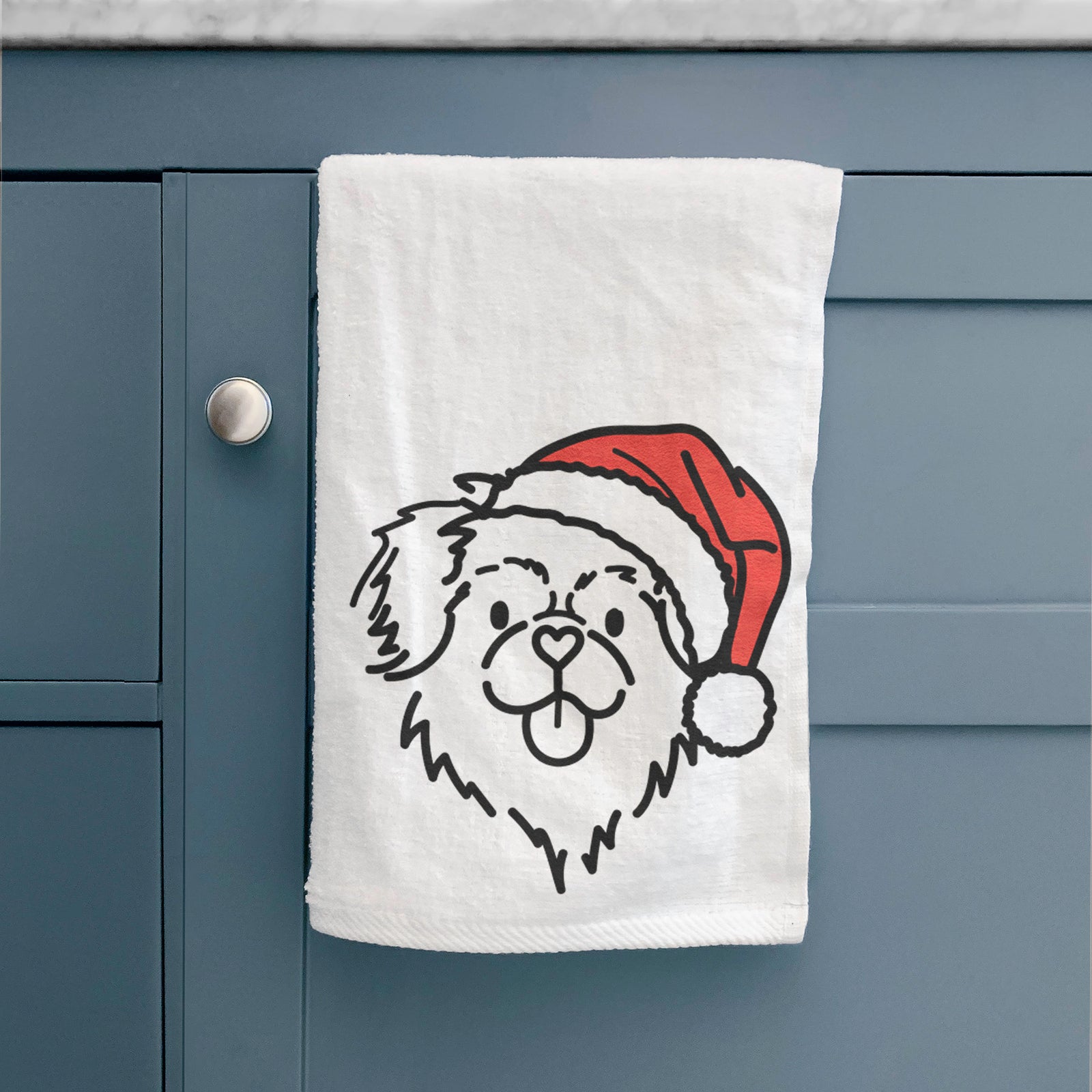 Minimalist line drawing of Jiji the Tibetan Spaniel wearing a Santa hat on a decorative hand towel