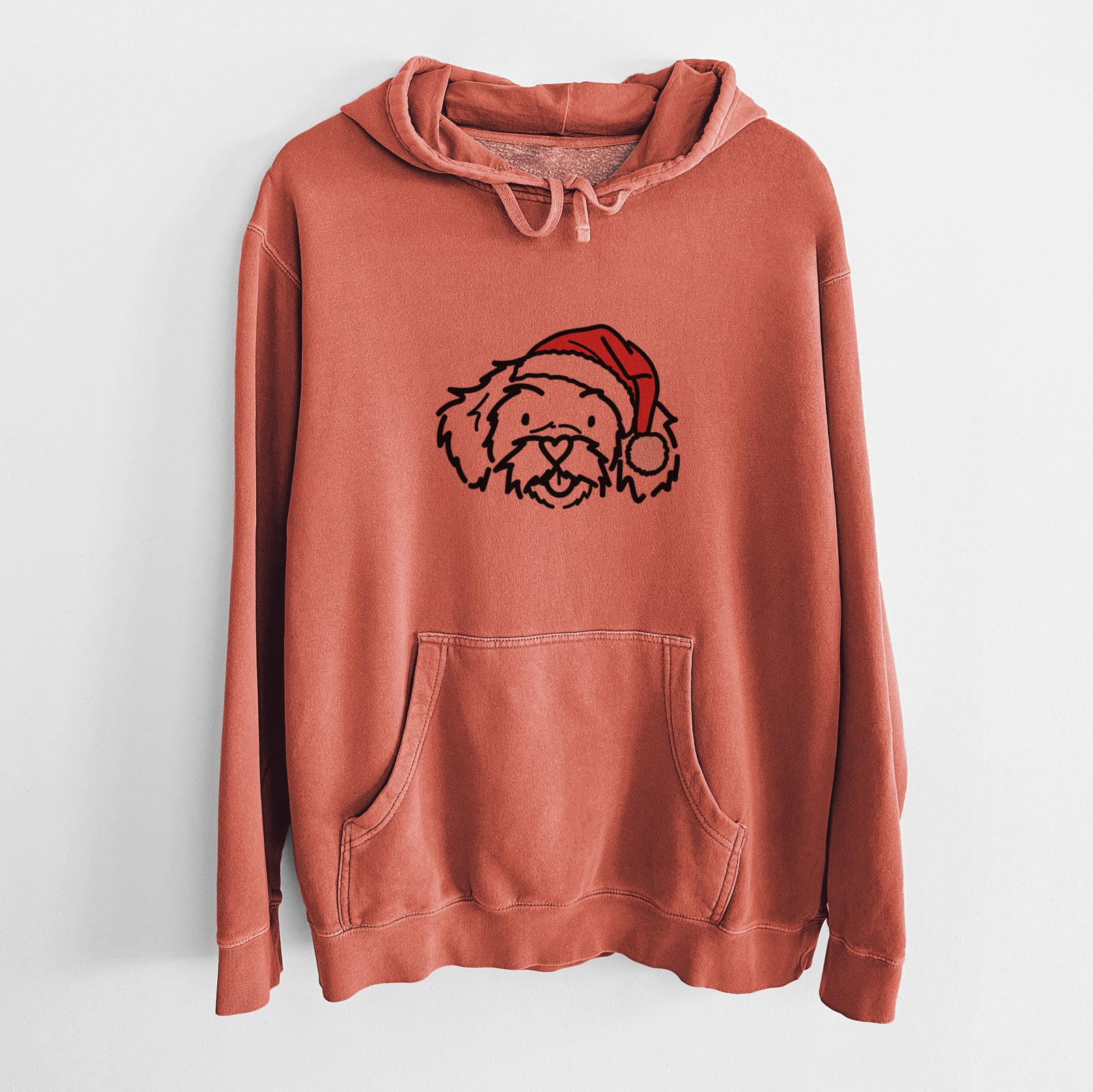 Minimalist line drawing of Jo Jo the Peekapoo wearing a Santa hat on an Amber Unisex pigment dyed hoodie