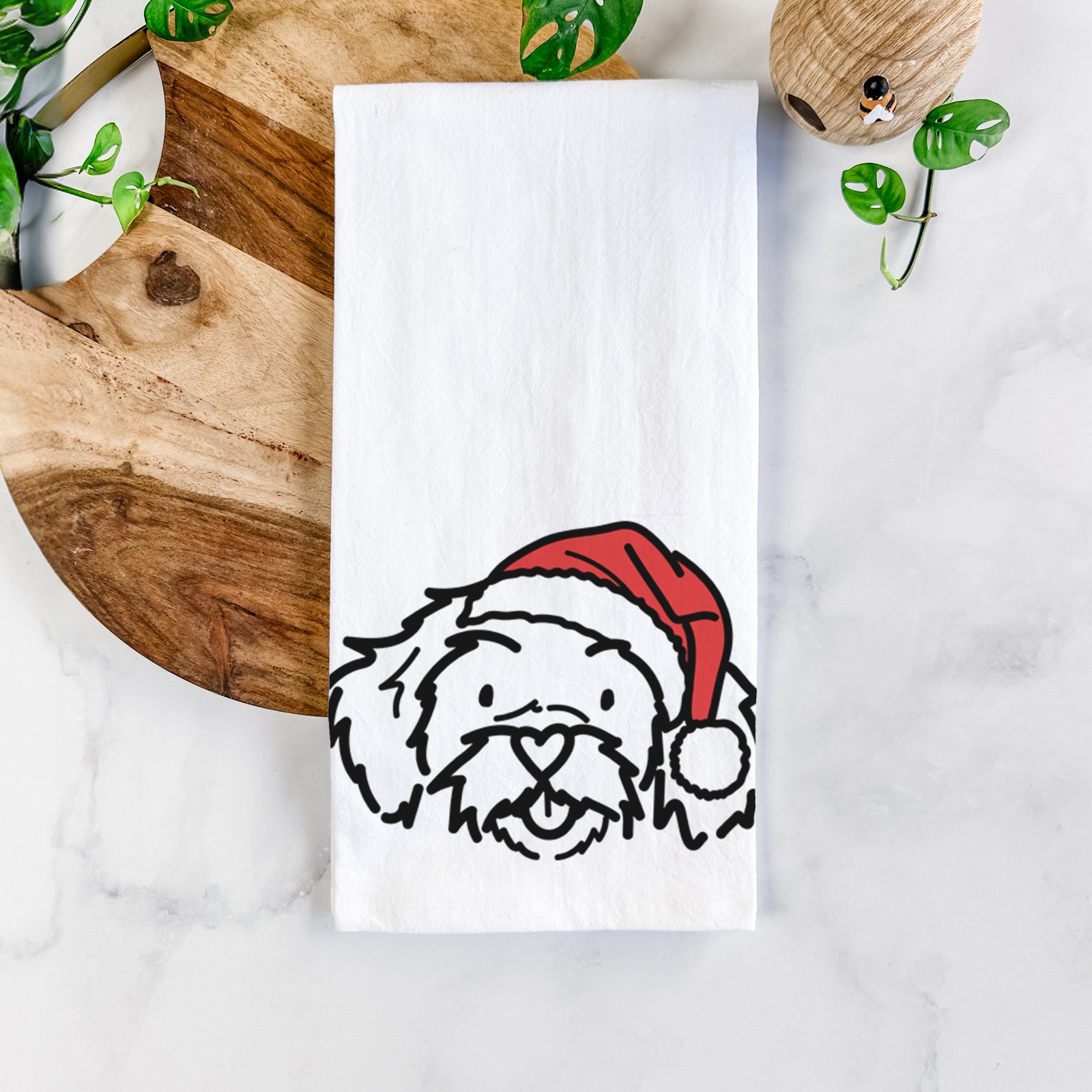 Minimalist line drawing of Jo Jo the Peekapoo wearing a Santa hat on a tea towel