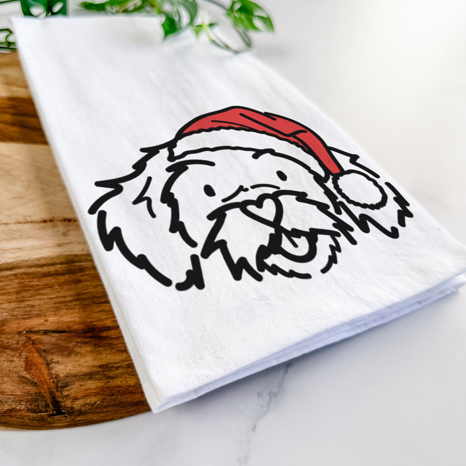Minimalist line drawing of Jo Jo the Peekapoo wearing a Santa hat on a tea towel