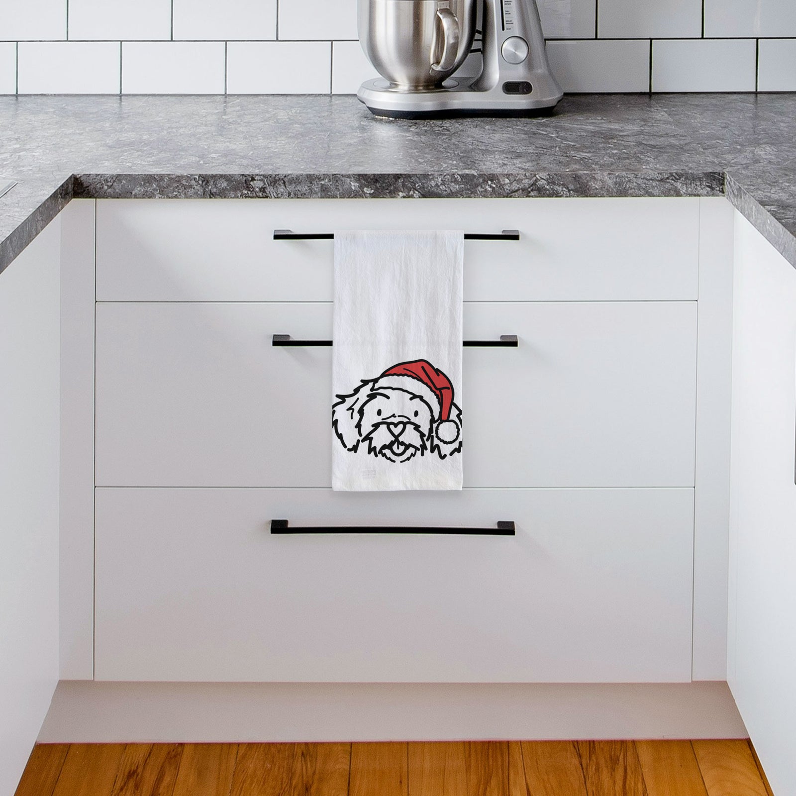 Minimalist line drawing of Jo Jo the Peekapoo wearing a Santa hat on a tea towel, hanging on an oven door in a kitchen