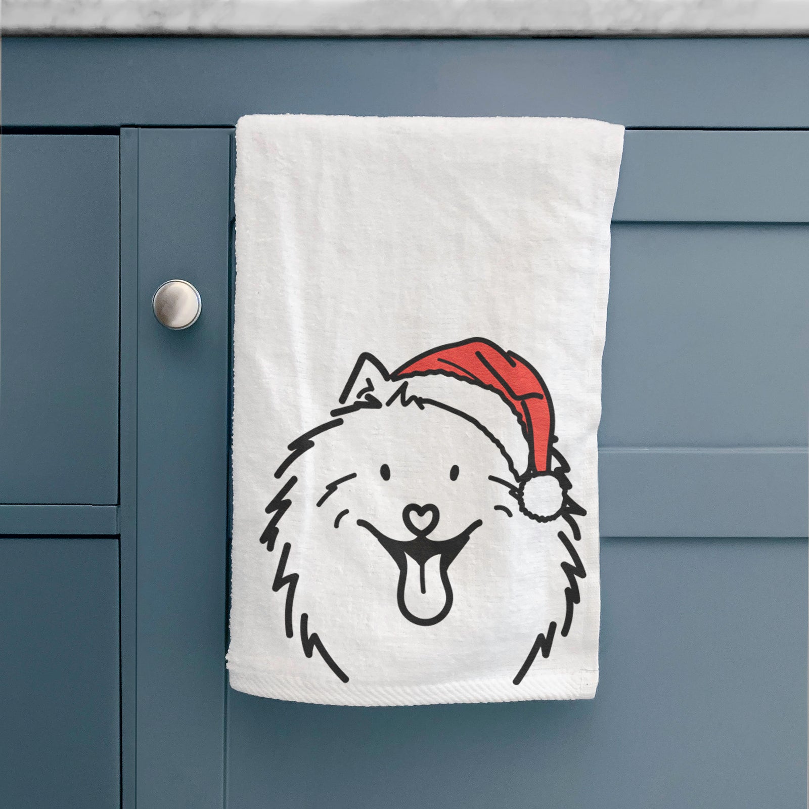 Minimalist line drawing of Johnny the Samoyed wearing a Santa hat on a hand towel
