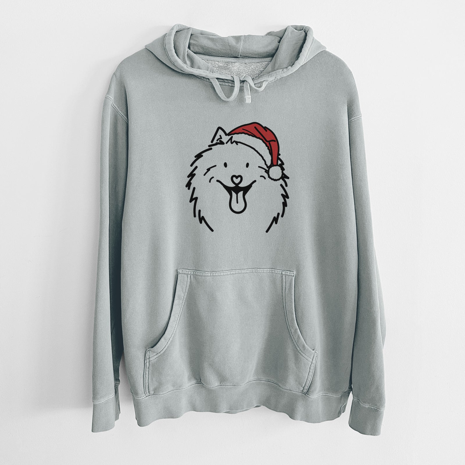 Minimalist line drawing of Johnny the Samoyed wearing a Santa hat on a Sage Unisex pigment dyed hoodie