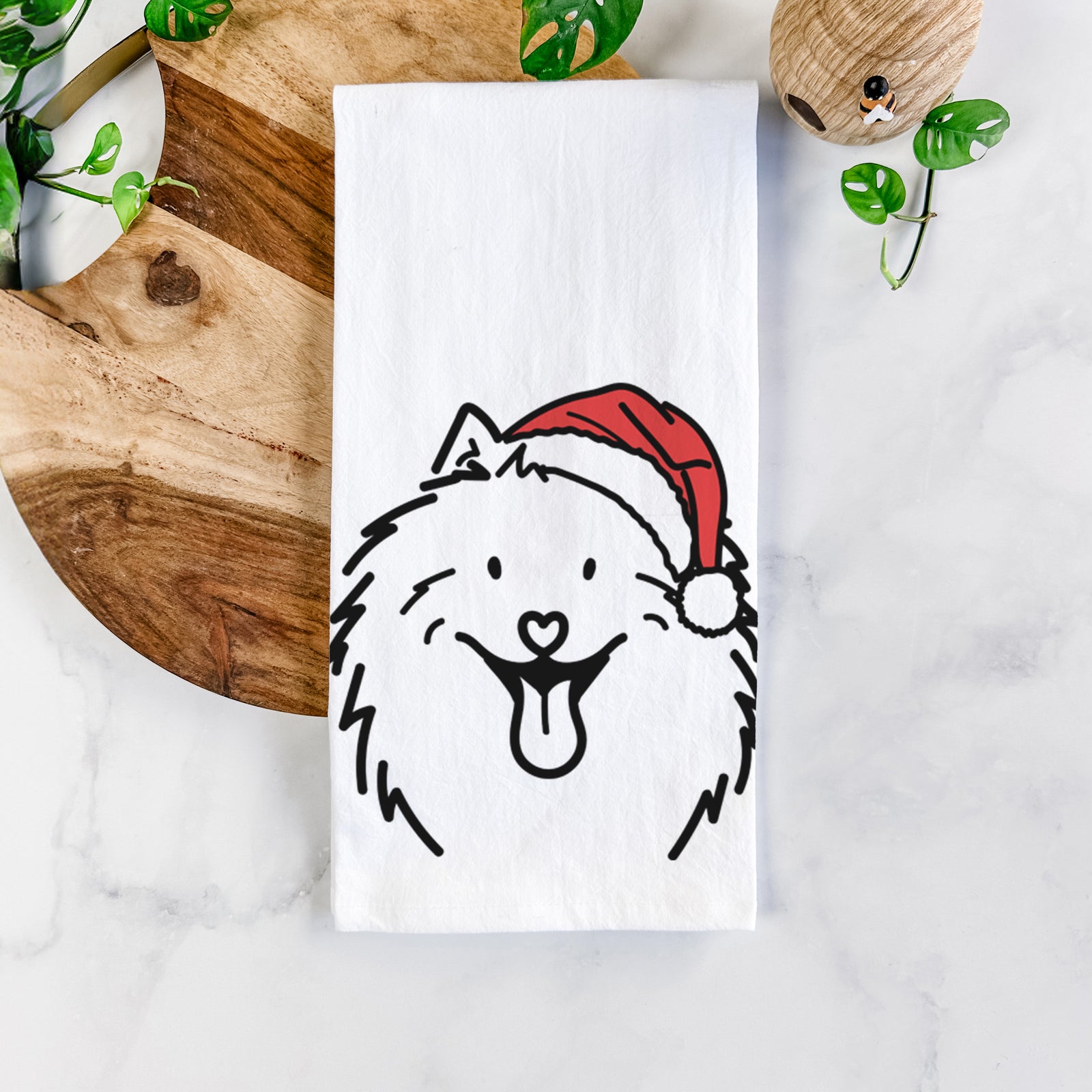 Minimalist line drawing of Johnny the Samoyed wearing a Santa hat on a tea towel
