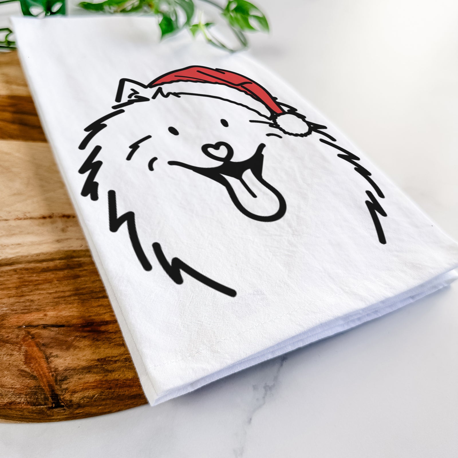 Minimalist line drawing of Johnny the Samoyed wearing a Santa hat on a tea towel