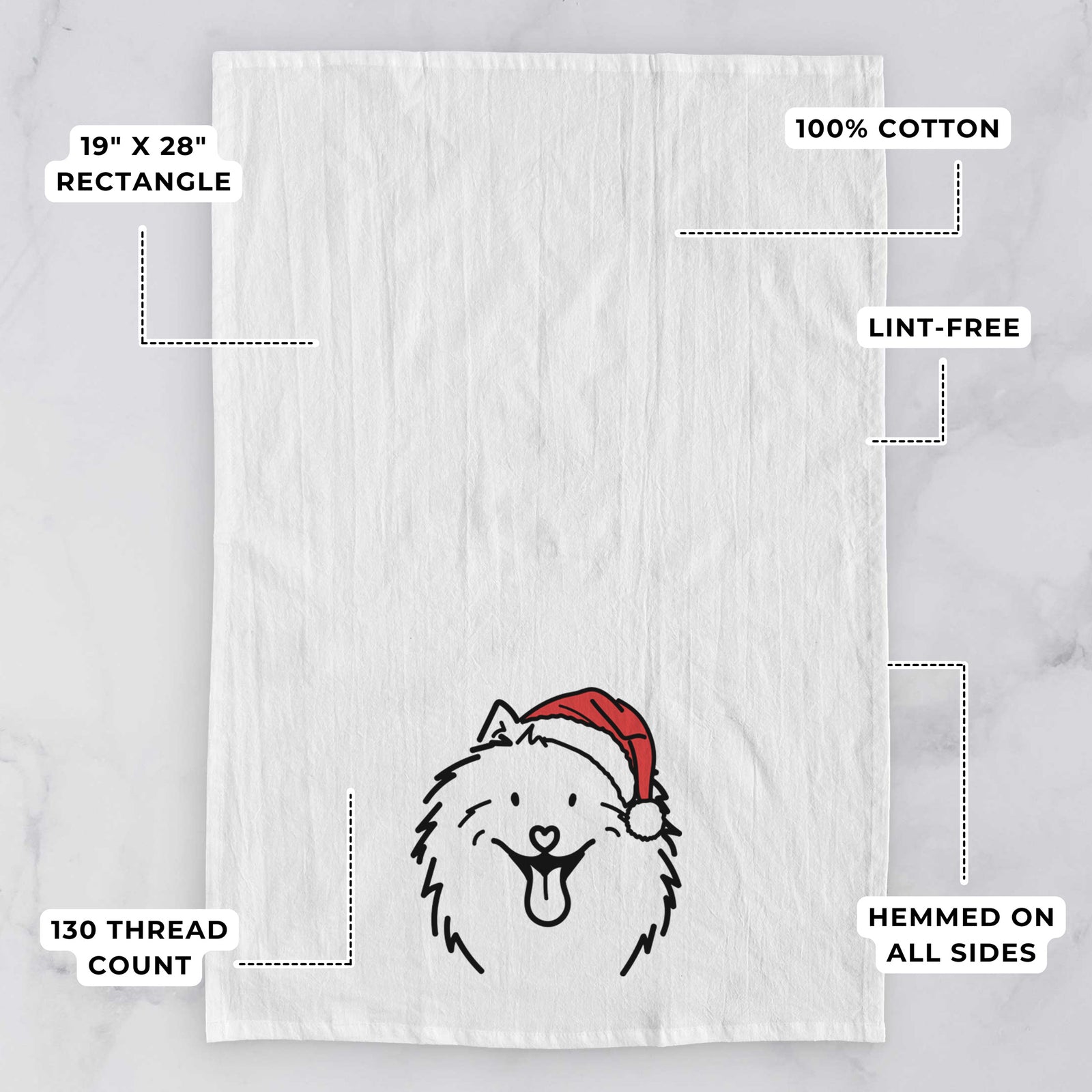 Minimalist line drawing of Johnny the Samoyed wearing a Santa hat on a tea towel, with feature callouts: 19 x 28 inch rectangle, 100% cotton, lint-free, 120 thread count, hemmed on all sides