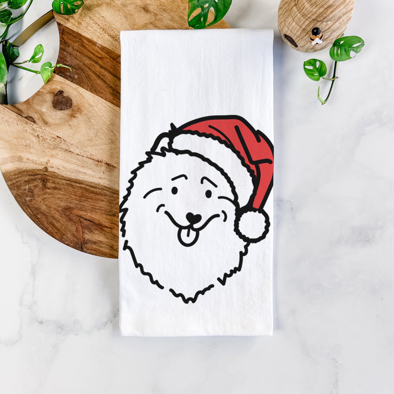 Minimalist line drawing of a Keeshond wearing a Santa hat on a tea towel
