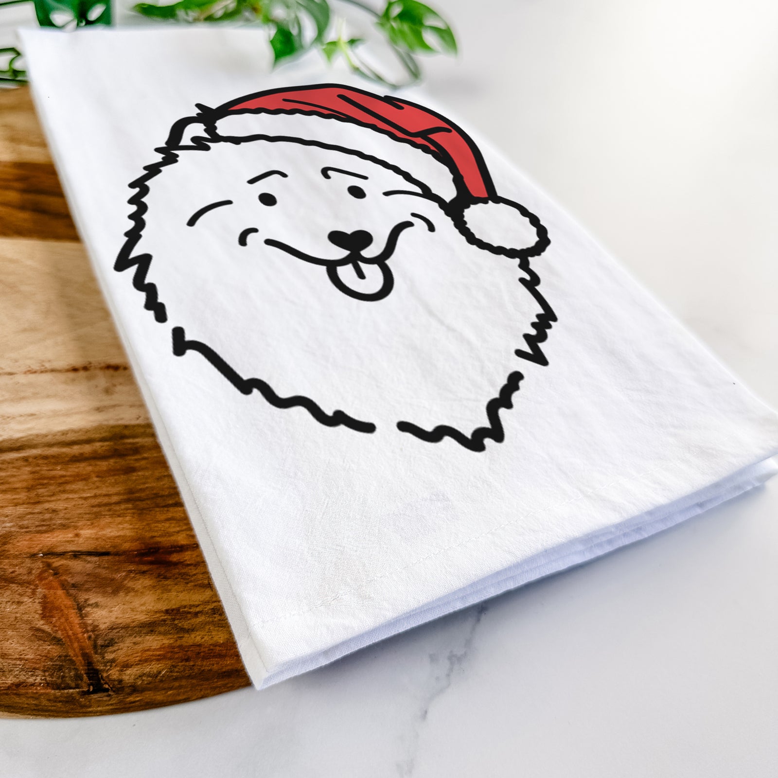 Minimalist line drawing of a Keeshond wearing a Santa hat on a tea towel