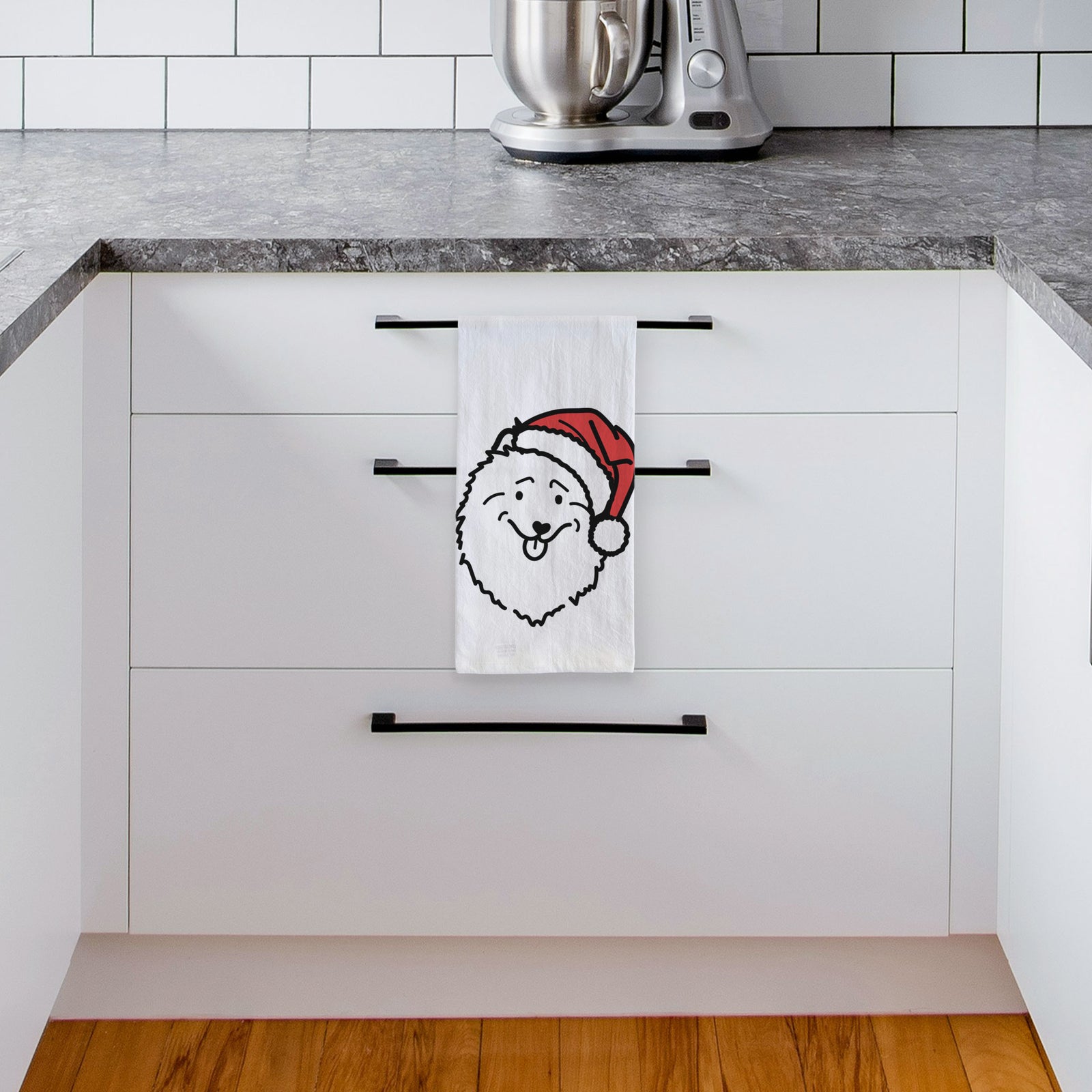 Minimalist line drawing of a Keeshond wearing a Santa hat on a tea towel, hanging on an oven door in a kitchen