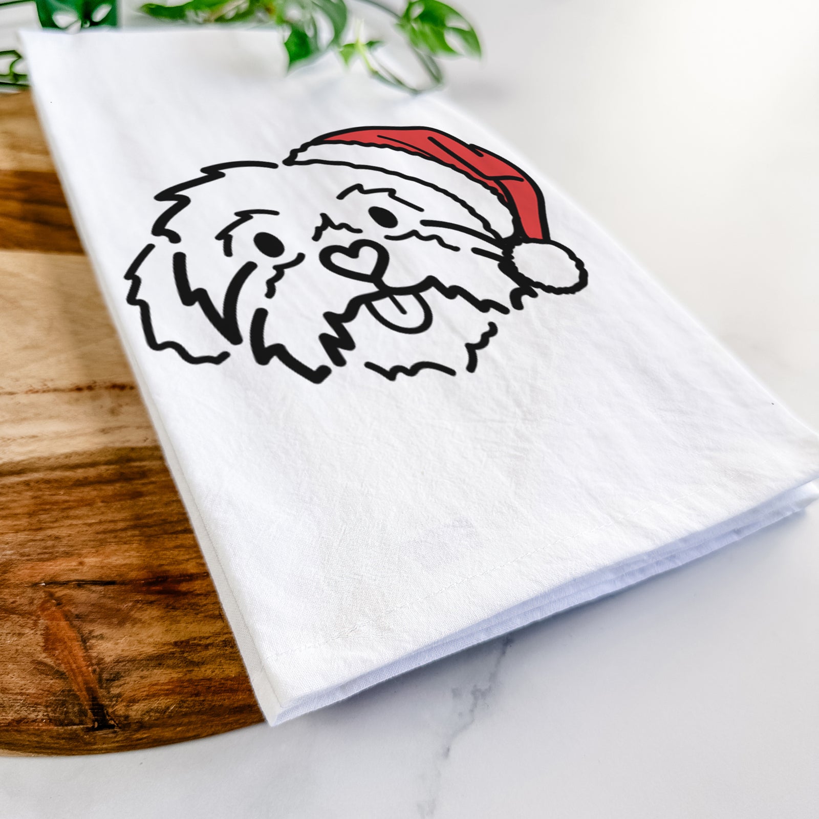 Minimalist line drawing of Leo the Shih Tzu wearing a Santa hat on a tea towel