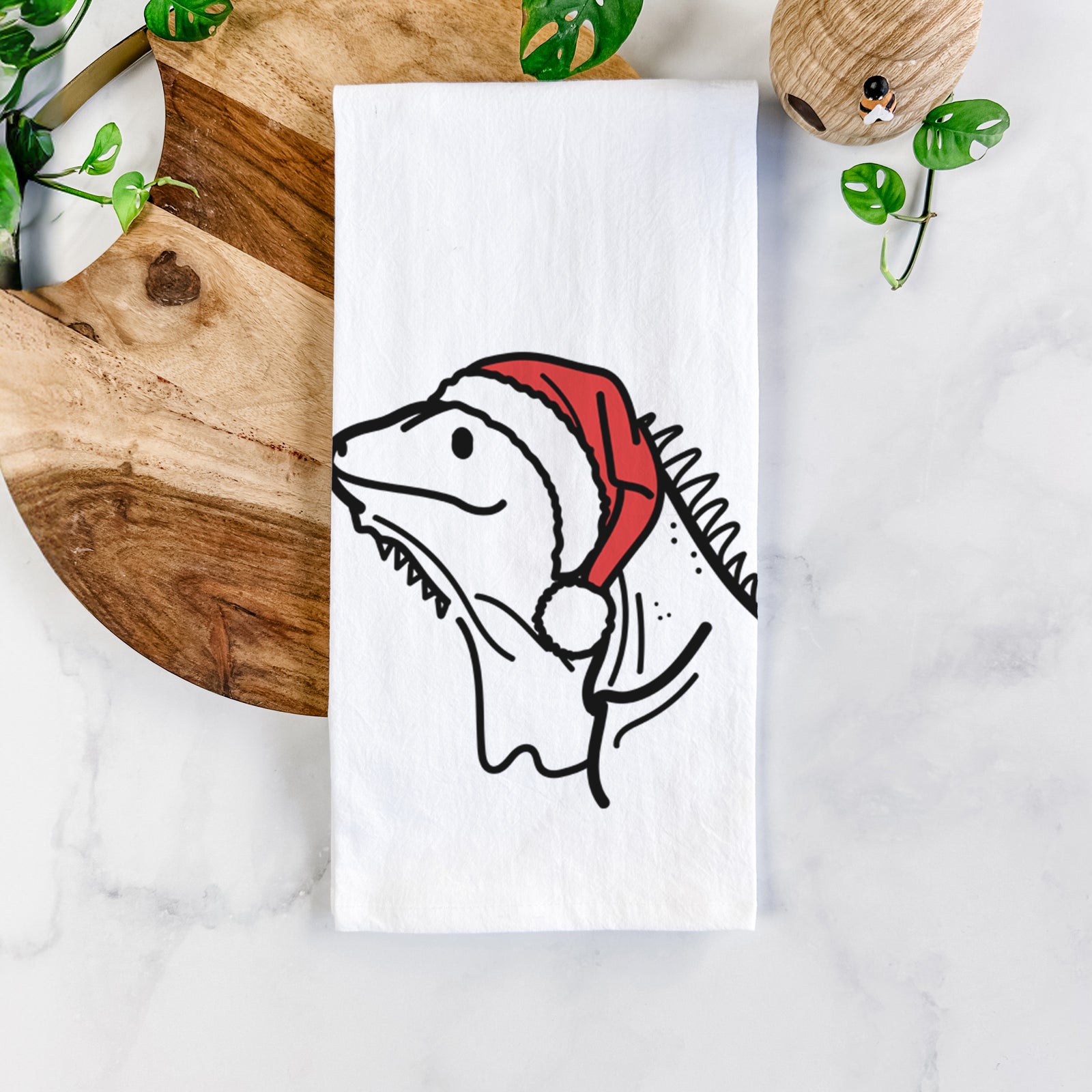 Minimalist line drawing of Louie the Iguana wearing a Santa hat on a tea towel