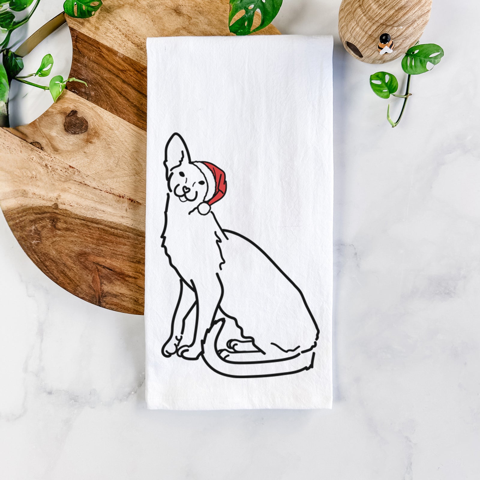 Minimalist line drawing of Lyra the Oriental Shorthair Cat wearing a Santa hat on a tea towel