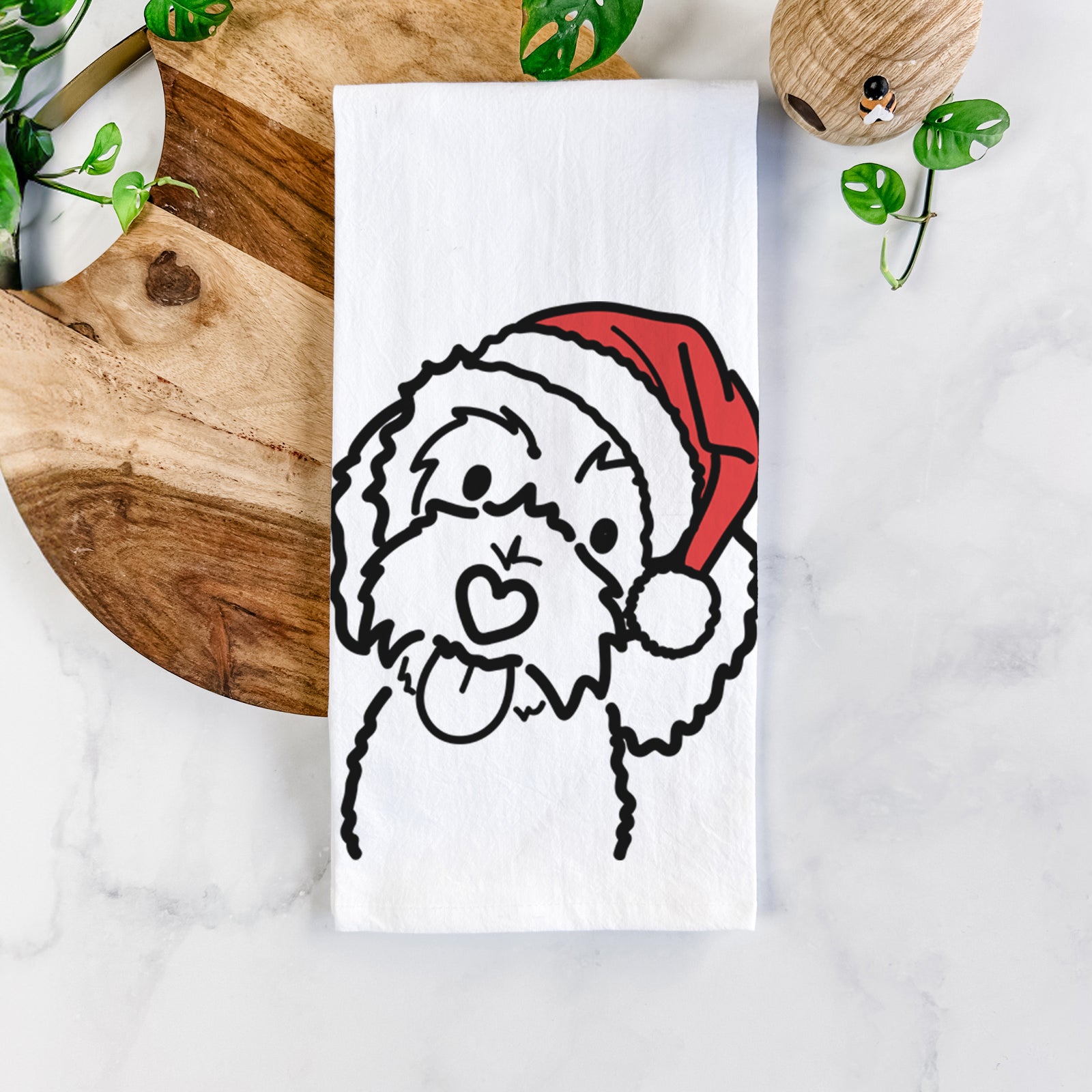 Minimalist line drawing of Mabel the Bernedoodle wearing a Santa hat on a tea towel