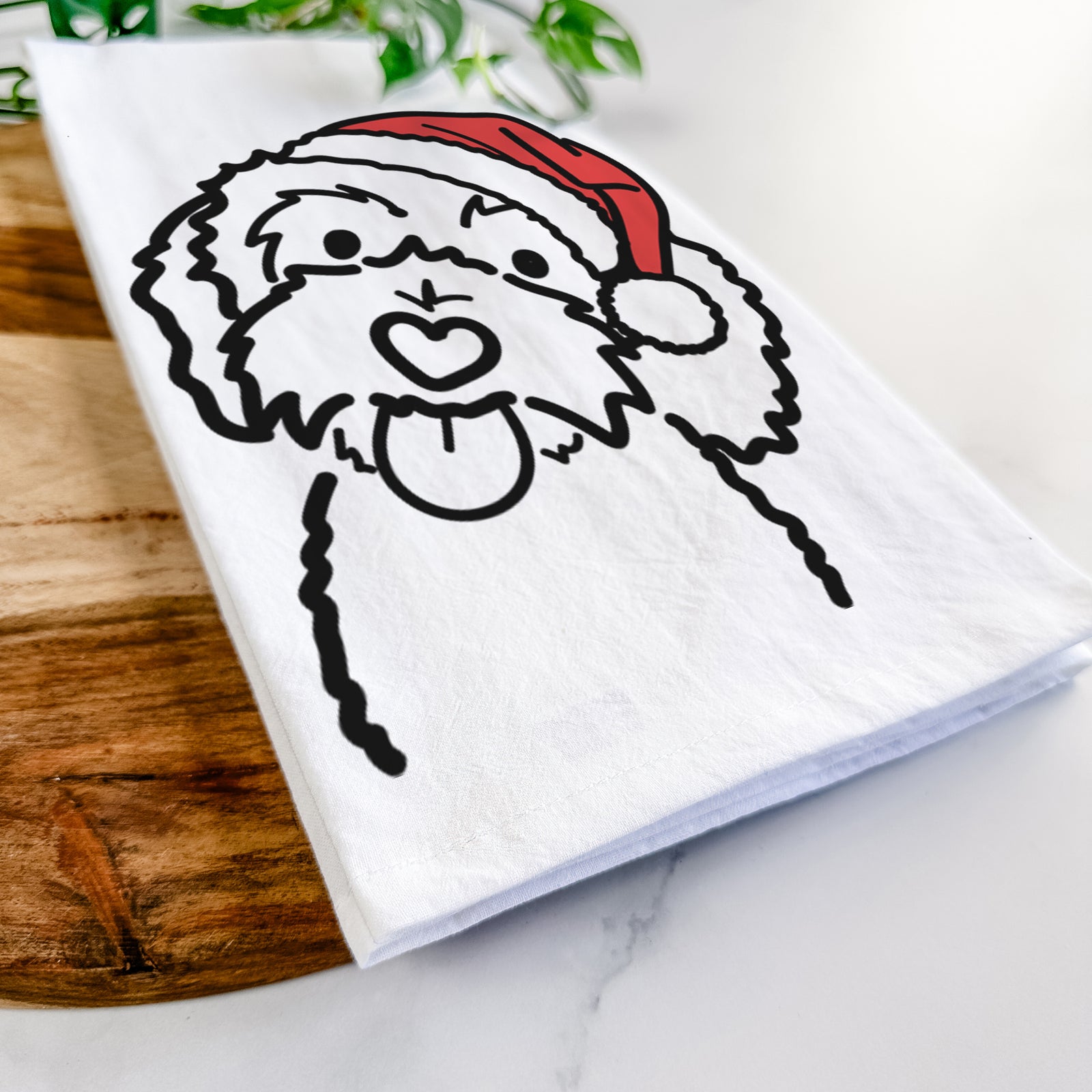 Minimalist line drawing of Mabel the Bernedoodle wearing a Santa hat on a tea towel