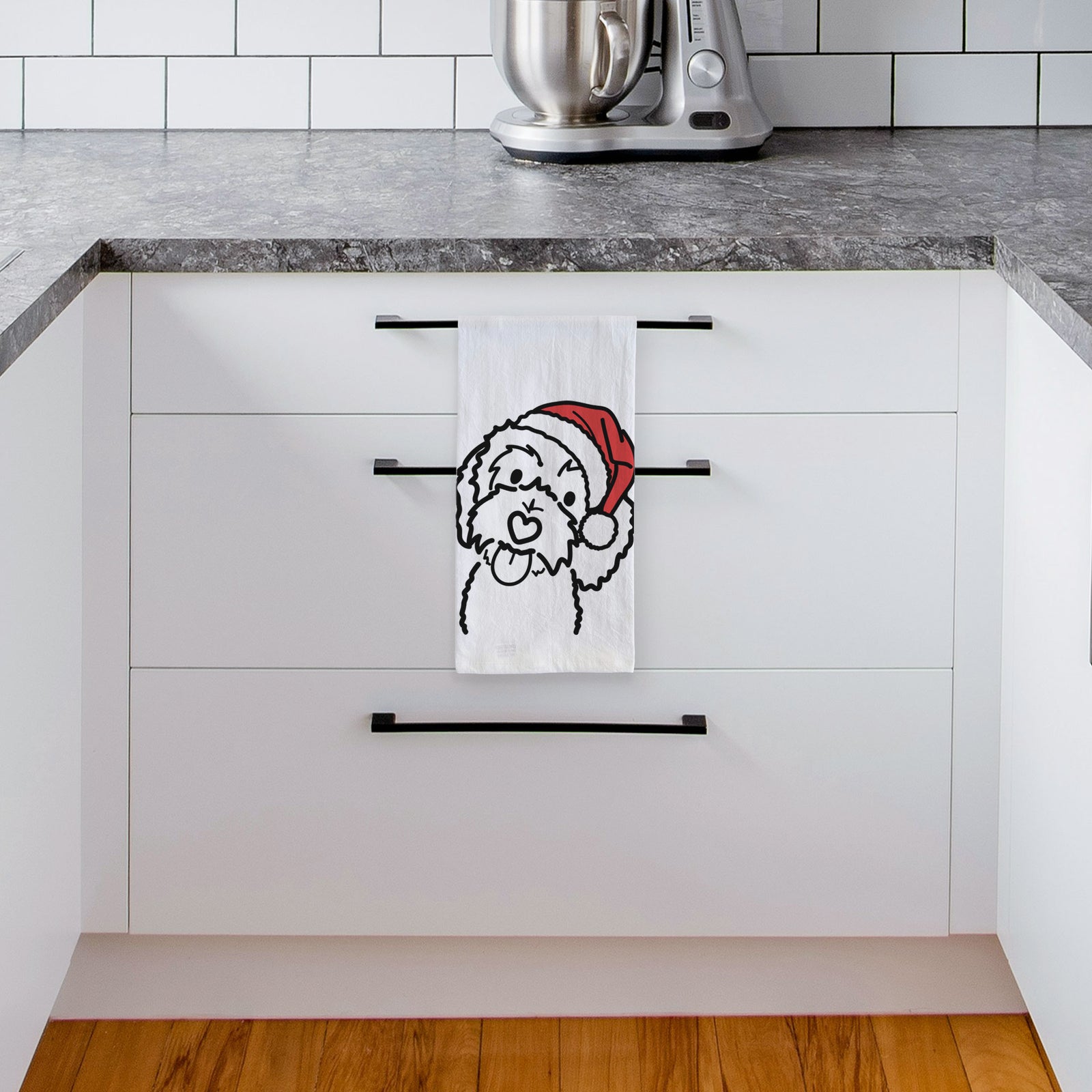 Minimalist line drawing of Mabel the Bernedoodle wearing a Santa hat on a tea towel, hanging on an oven door in a kitchen