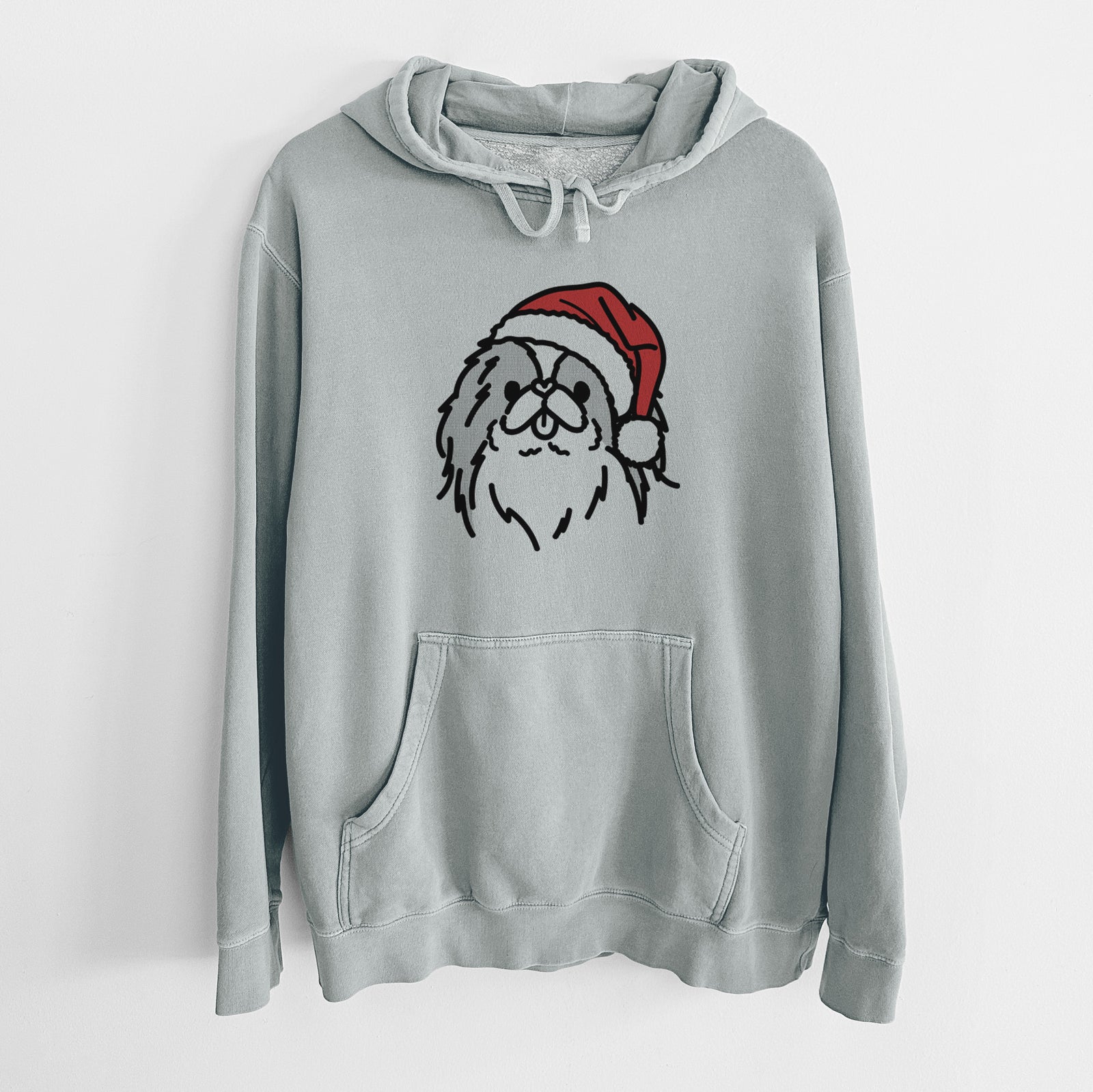 Minimalist line drawing of Macha the Japanese Chin wearing a Santa hat on a Sage Unisex pigment dyed hoodie