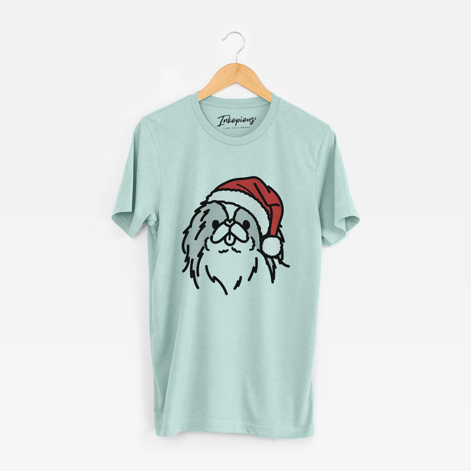 Minimalist line drawing of Macha the Japanese Chin wearing a Santa hat on a Heather Sage Unisex crewneck