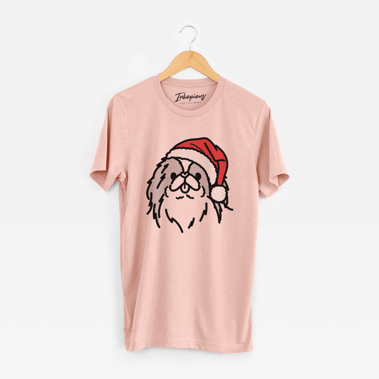 Minimalist line drawing of Macha the Japanese Chin wearing a Santa hat on a Peach Unisex crewneck