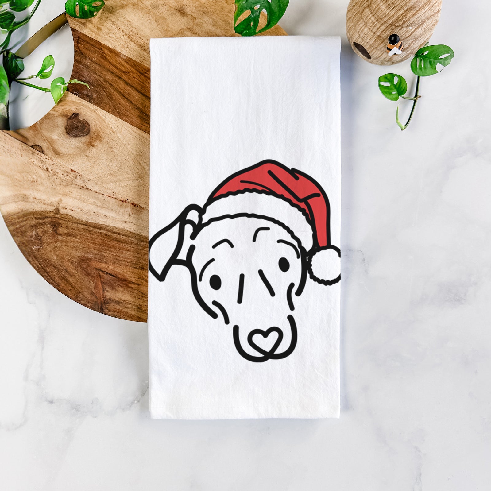 Minimalist line drawing of Millie the Mixed Breed wearing a Santa hat on a tea towel