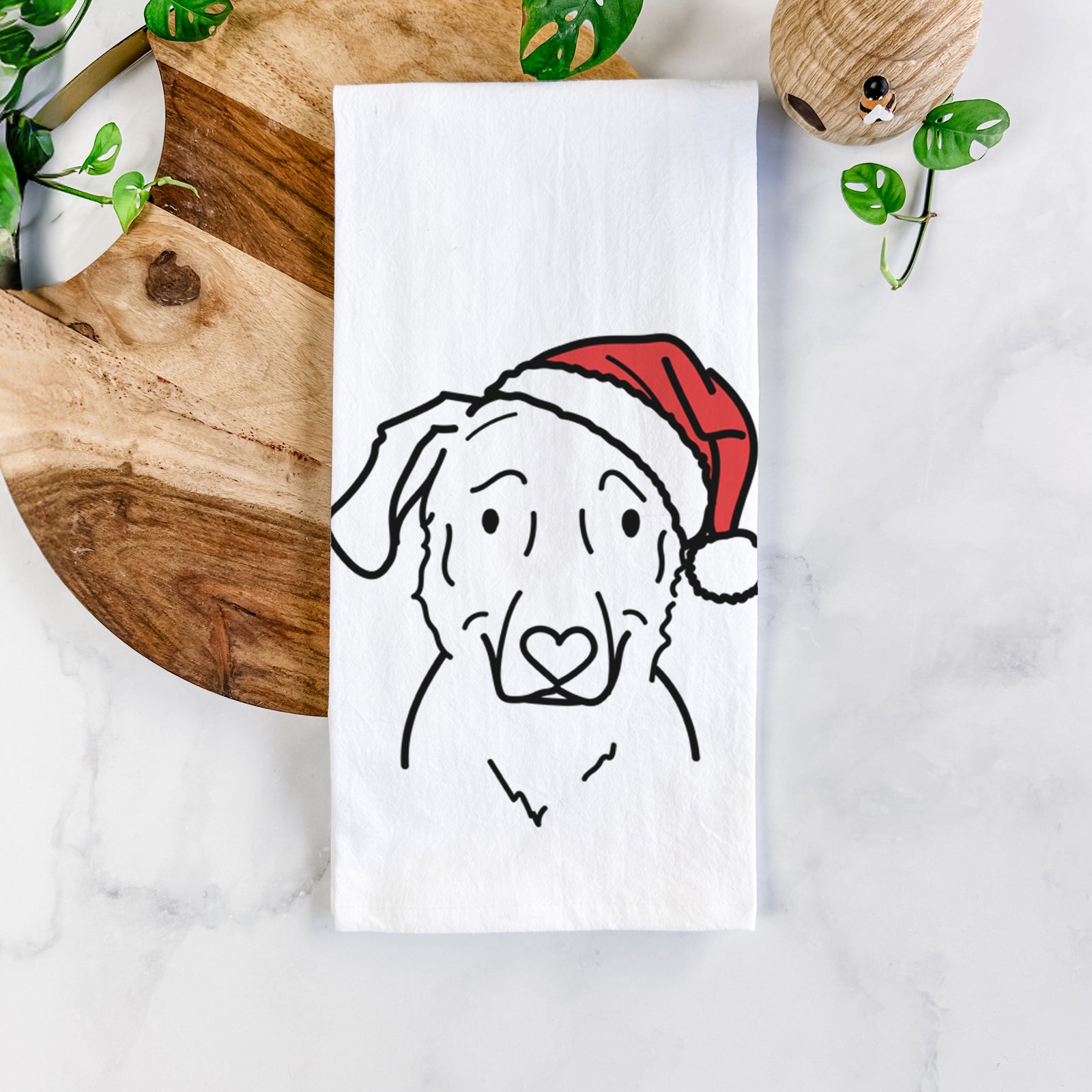 Minimalist line drawing of Mitzi the Golden Retriever Mix wearing a Santa hat on a tea towel