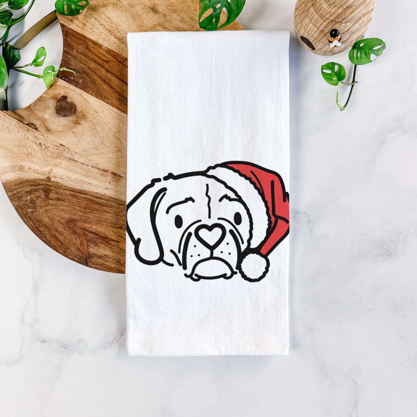 Minimalist line drawing of Mitzi the Puggle wearing a Santa hat on a tea towel