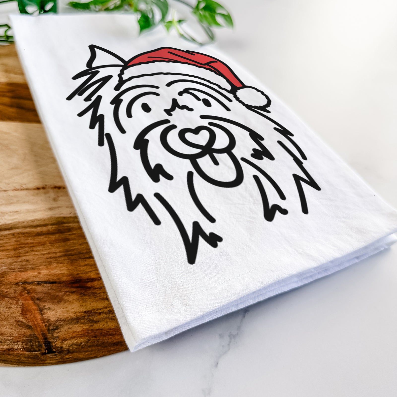 Minimalist line drawing of Monty the Silky Terrier wearing a Santa hat on a tea towel
