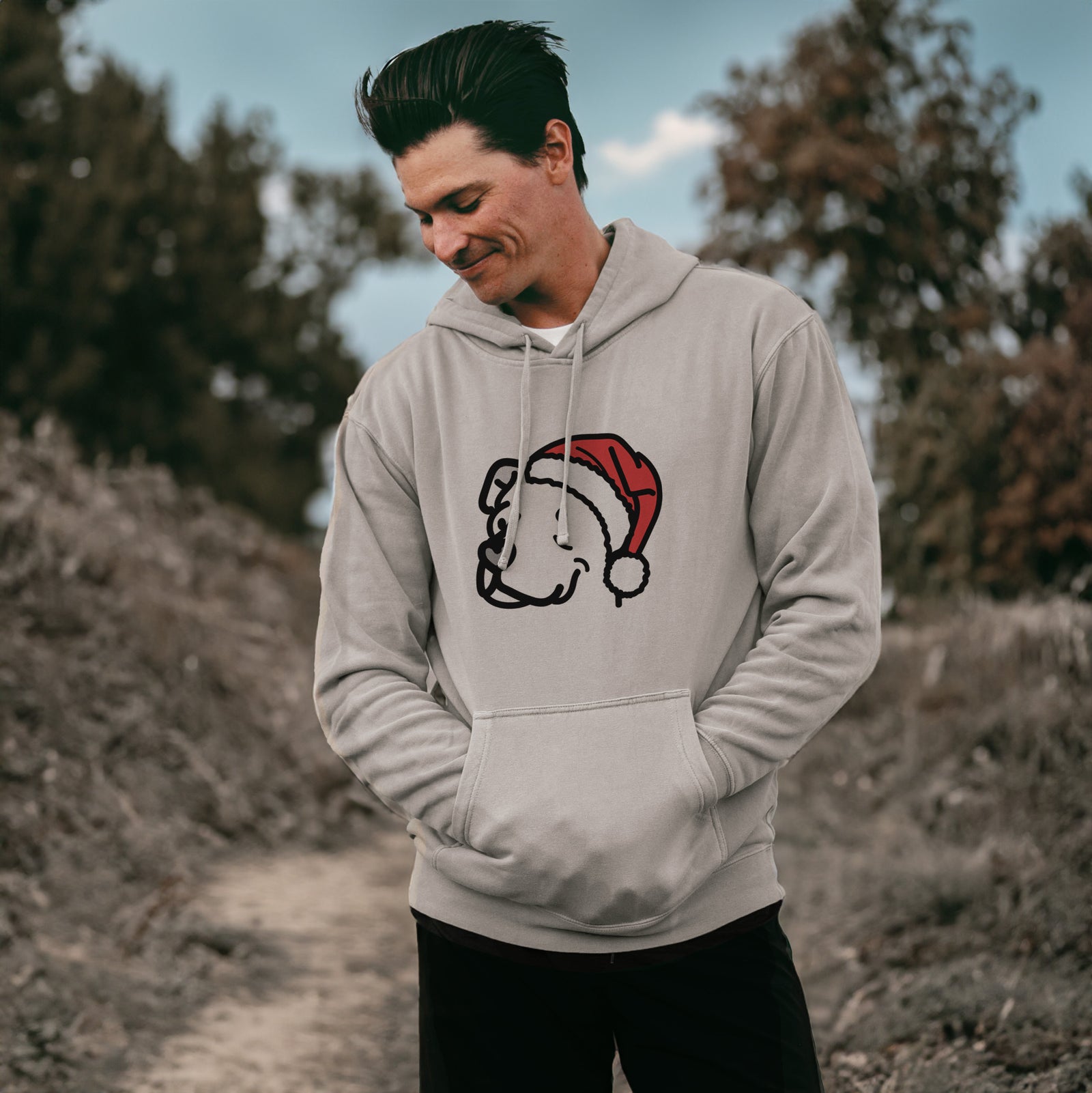 Minimalist line drawing of Mr. Sir the Pitbull Mix wearing a Santa hat on a Cement Unisex pigment dyed hoodie, worn by a man