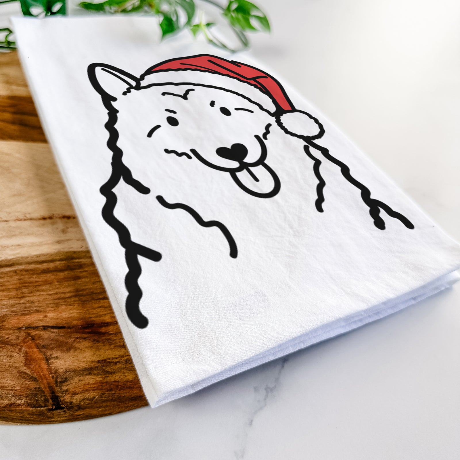 Minimalist line drawing of a Norwegian Elkhound wearing a Santa hat on a tea towel