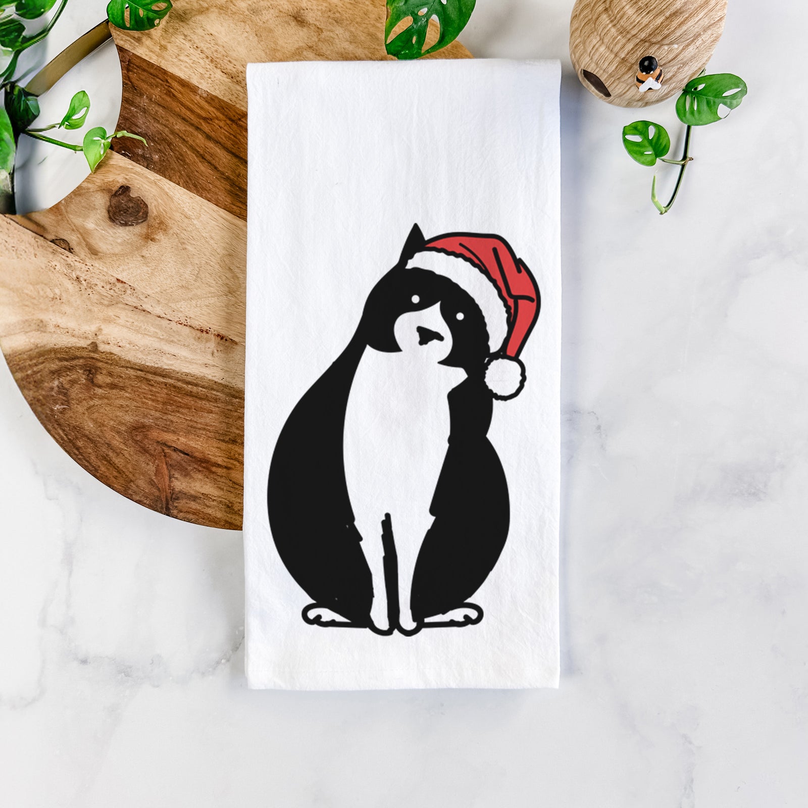Minimalist line drawing of Oliver the Tuxedo Cat wearing a Santa hat on a tea towel