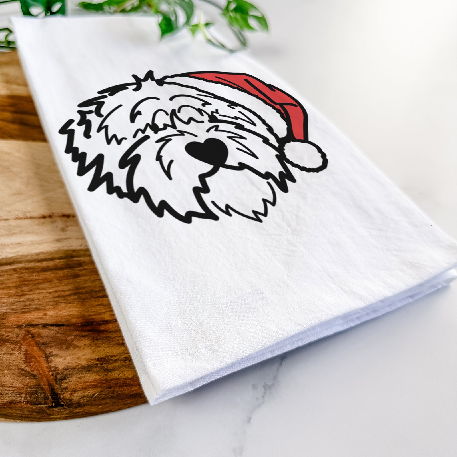 Minimalist line drawing of Penny the Old English Sheepdog wearing a Santa hat on a tea towel