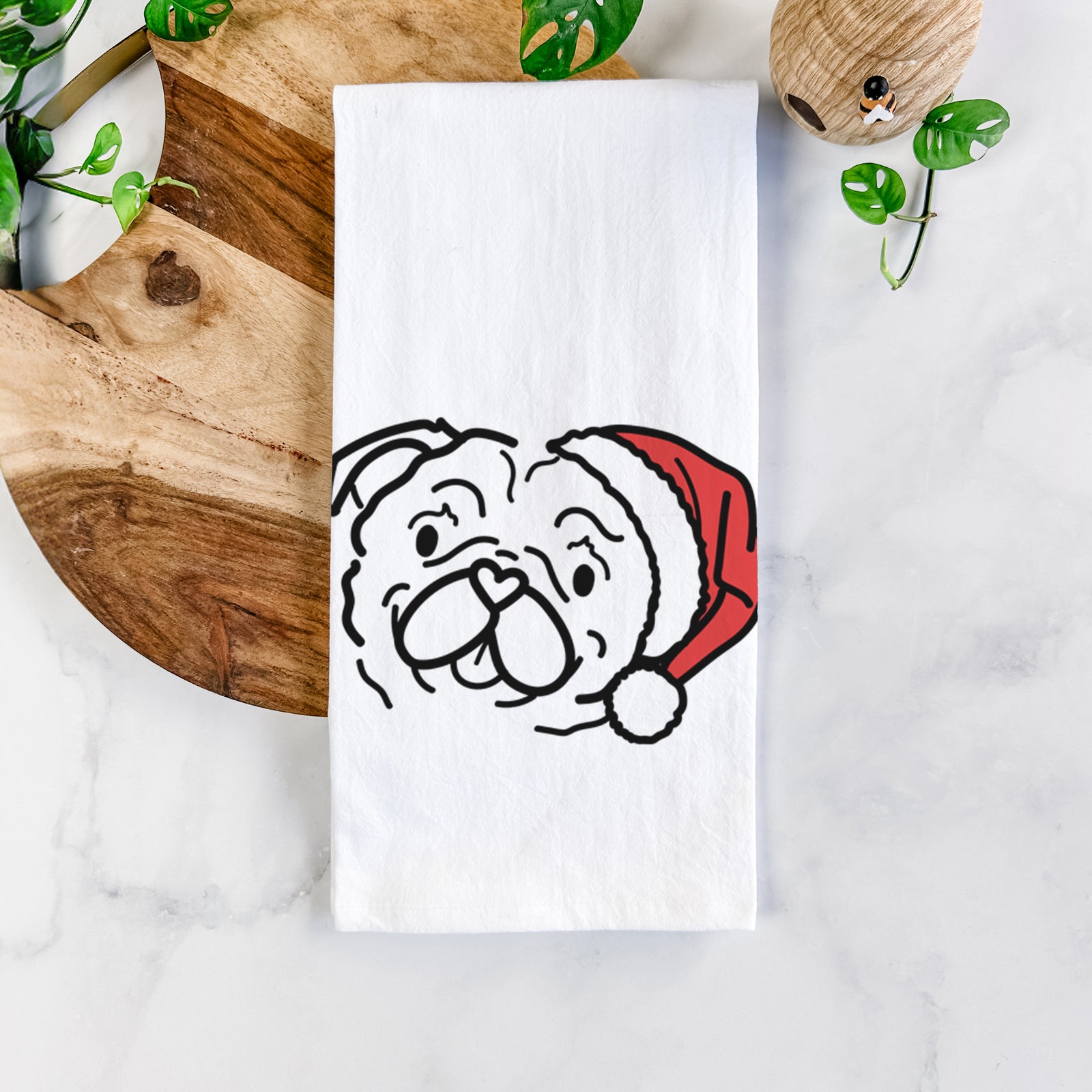 Minimalist line drawing of Pip the Pug wearing a Santa hat on a tea towel