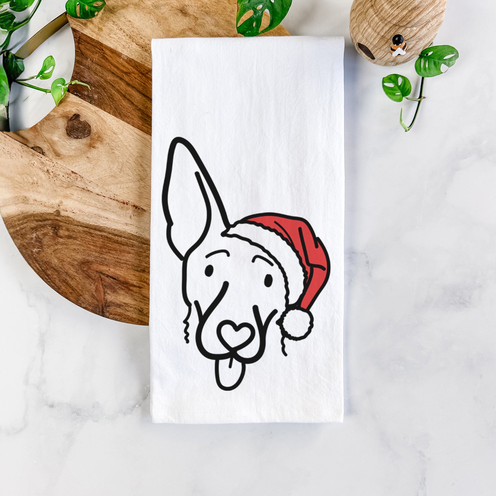 Minimalist line drawing of Rosie the Shepherd Mix wearing a Santa hat on a tea towel