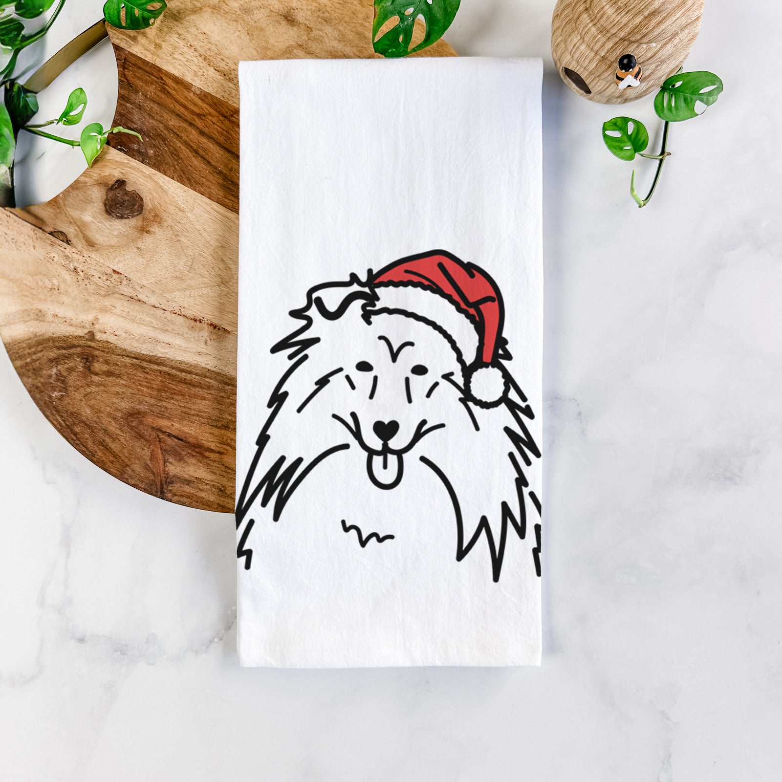 Minimalist line drawing of a Rough Collie wearing a Santa hat on a tea towel