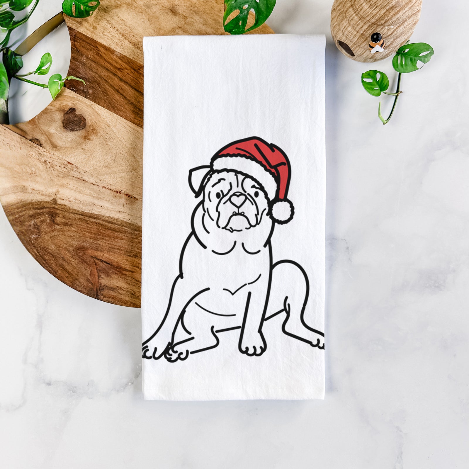 Minimalist line drawing of Rudy the Pug wearing a Santa hat on a tea towel