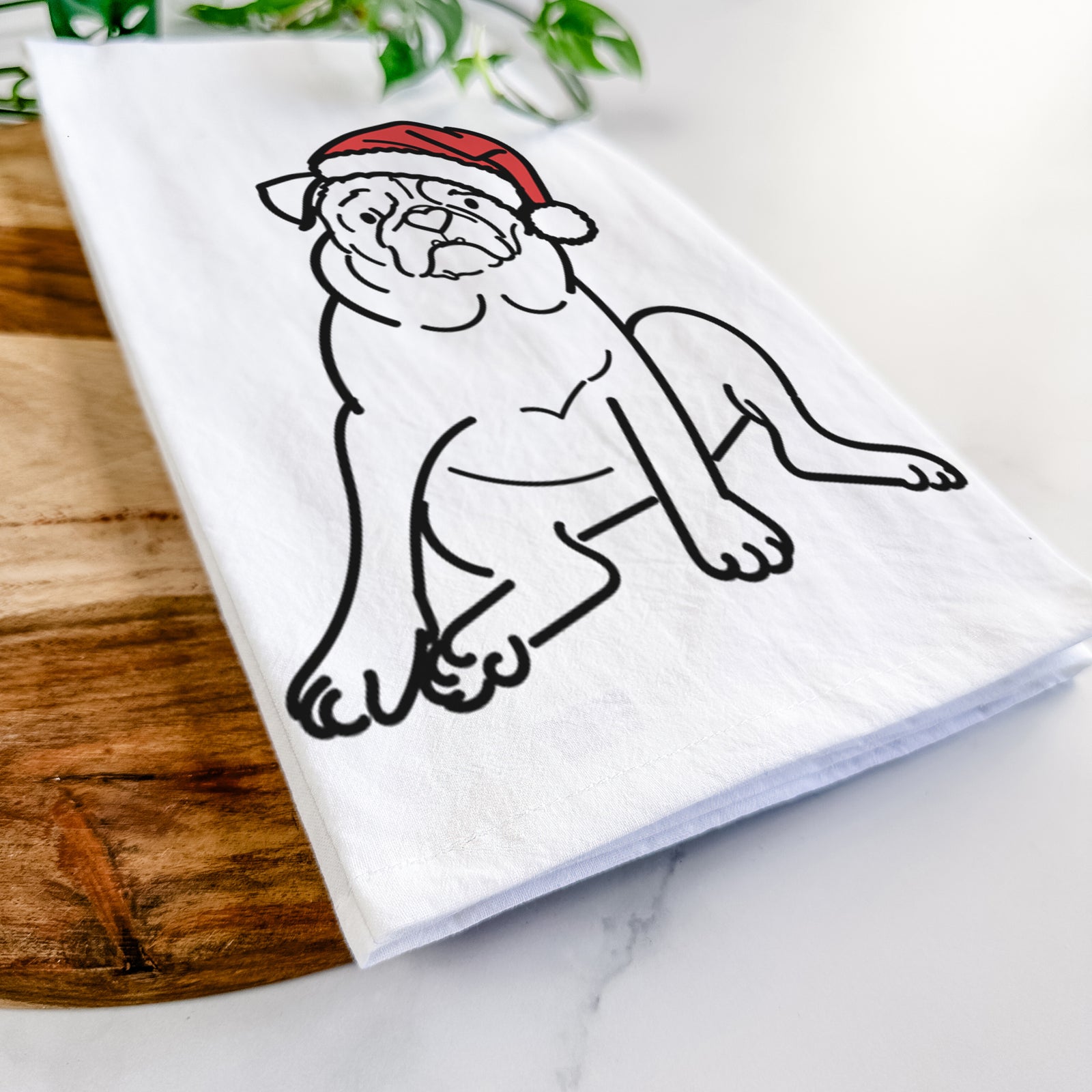 Minimalist line drawing of Rudy the Pug wearing a Santa hat on a tea towel
